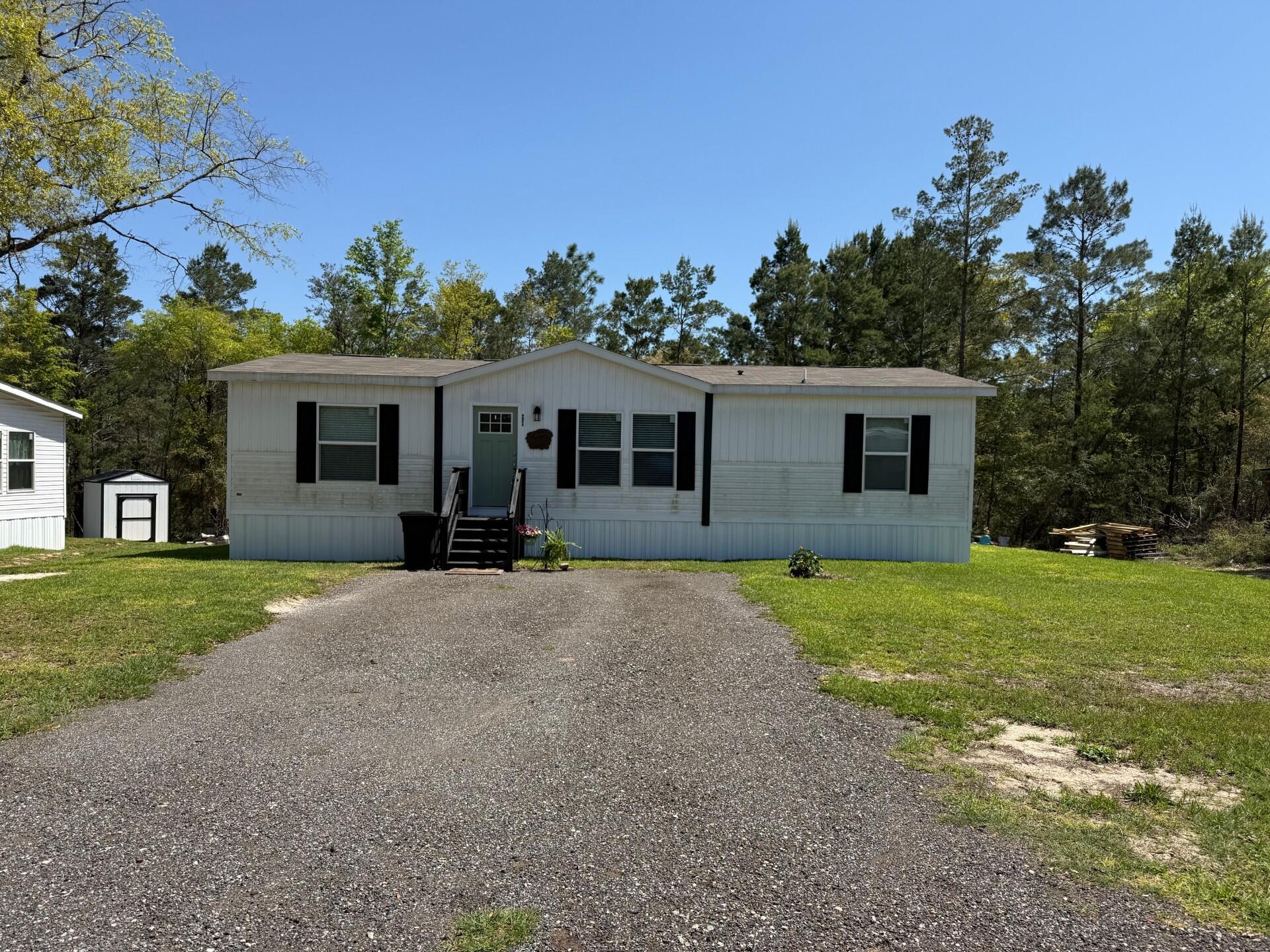 Don't miss out on this beautiful 2023 Manufactured Home with oversized half acre yard! When you first walk in you see the open living room space with a beautiful accent wall, along with a large Master bedroom, the bathroom has a beautiful walk-in shower. The closet is huge with a ton of extra storage. There are 2 additional bedrooms and 2 full bathrooms and upgraded cabinetry and appliances.