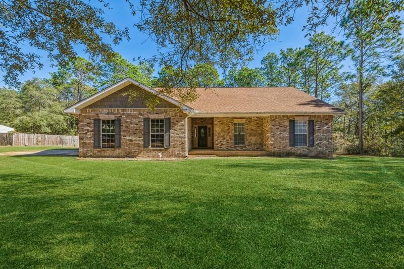 When you first go into this custom built home you will first notice the Cathedral ceilings followed by the cornered gas fireplace. This home features an open floor plan with laminate wood floors throughout the main living area and master bedroom. There is tile in the kitchen and bathrooms. The kitchen features granite counter tops, tumbled stone back splash and dark cherry cabinets.The kitchen also has a walk-in pantry, black appliances consisting of a counter depth Kenmore refrigerator, combination wall oven and microwave, dishwasher, and cooktop. The master bedroom features a small nook along with a door out to the covered patio. Master bathroom includes tiled shower, large jacuzzi