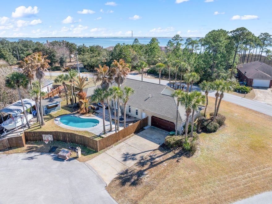 Welcome to this charming POOL HOME on The Emerald Coast! Right near the county line, this home is located in the beautiful Emerald Pointe neighborhood in Mary Esther. Close to Navarre and also a quick commute to Hurlburt Field AFB. This home is one of a kind due to the location, features and beach access amenities. For a voluntary 225 per year, you can access the boardwalk to the beach to go kayak, paddle board or lounge with the family and friends. You have views of Navarre Beach bridge from here as well. Quick ride over there on a wave runner. As soon as you pull up to Wynnhaven pool home, you will notice the large lot size entering the cut-de-sac. So much parking with the garage located on the back side of the home. You will notice nearly 30 palm trees and other lush landscaping. The mature trees are sky high around the property creating paradise in your backyard. Other features are a workshop/ pool house right off of the back deck. There is an additional parking space for a large camper or boat. Bring all of your recreational toys here because there is plenty of storage and room. 
The home has been updated with a beatiful LVP flooring choice, trendy white fireplace, neutral wall colors and professionally redone cabinets and hardware. Please request your private tour today! Sellers are flexible with a closing date. Thank you for your interest!! Please ask your agent for additional videos of the beach that we can share. 