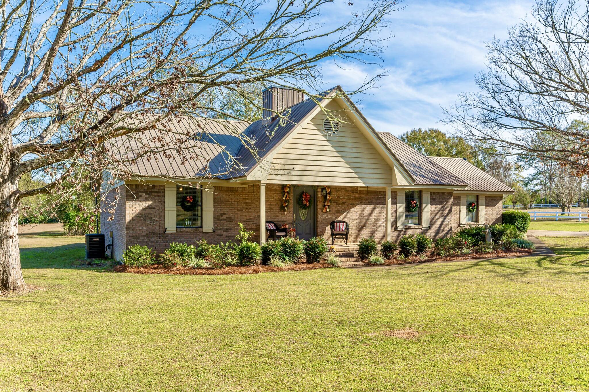 Check out this beautifully maintained 3 bd/2 ba ranch style home located in the heart of Baker. Situated on 2 acres, this property is a 'stone's throw' from Baker School (Grades K-12) and near the local grocery store. The home has an inviting front porch and inside you will find an open floor plan and a coziness and warmth about the place. The spacious living room features a wood burning fireplace with beautiful white washed surround. Functional kitchen w/ center island, gas cooking and solid surface countertops. The home has both a breakfast area and formal dining area. The screened in porch creates an extension of your living space for large gatherings and such and there is an open grilling deck off the side. A nice workshop with lean to has both power and water and is located out