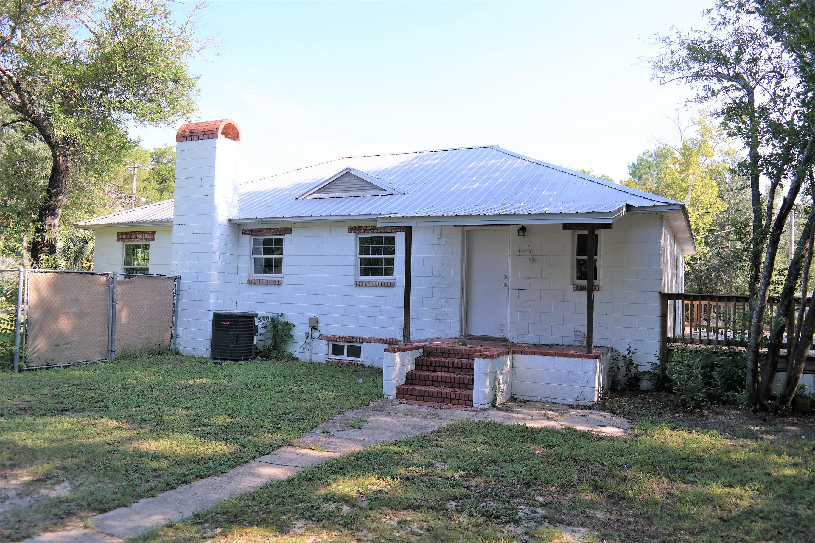 Great location in city limits with public water and sewer! This completely renovated Florida cottage sits on almost 1/2 acre corner lot, with fenced back yard. Metal roof was installed apx. 6 years ago. All other renovations were completed in 2018 and 2019. Quartz countertops in kitchen and bath; Stainless steel appliances; quality laminate flooring throughout; New HVAC, electrical, plumbing, double pane windows and more! There is also an unfinished basement off the laundry room for additional storage or shelter from the storms. This block home is solid and very energy efficient. You'll definitely want to put this one on your must see list...won't last long!