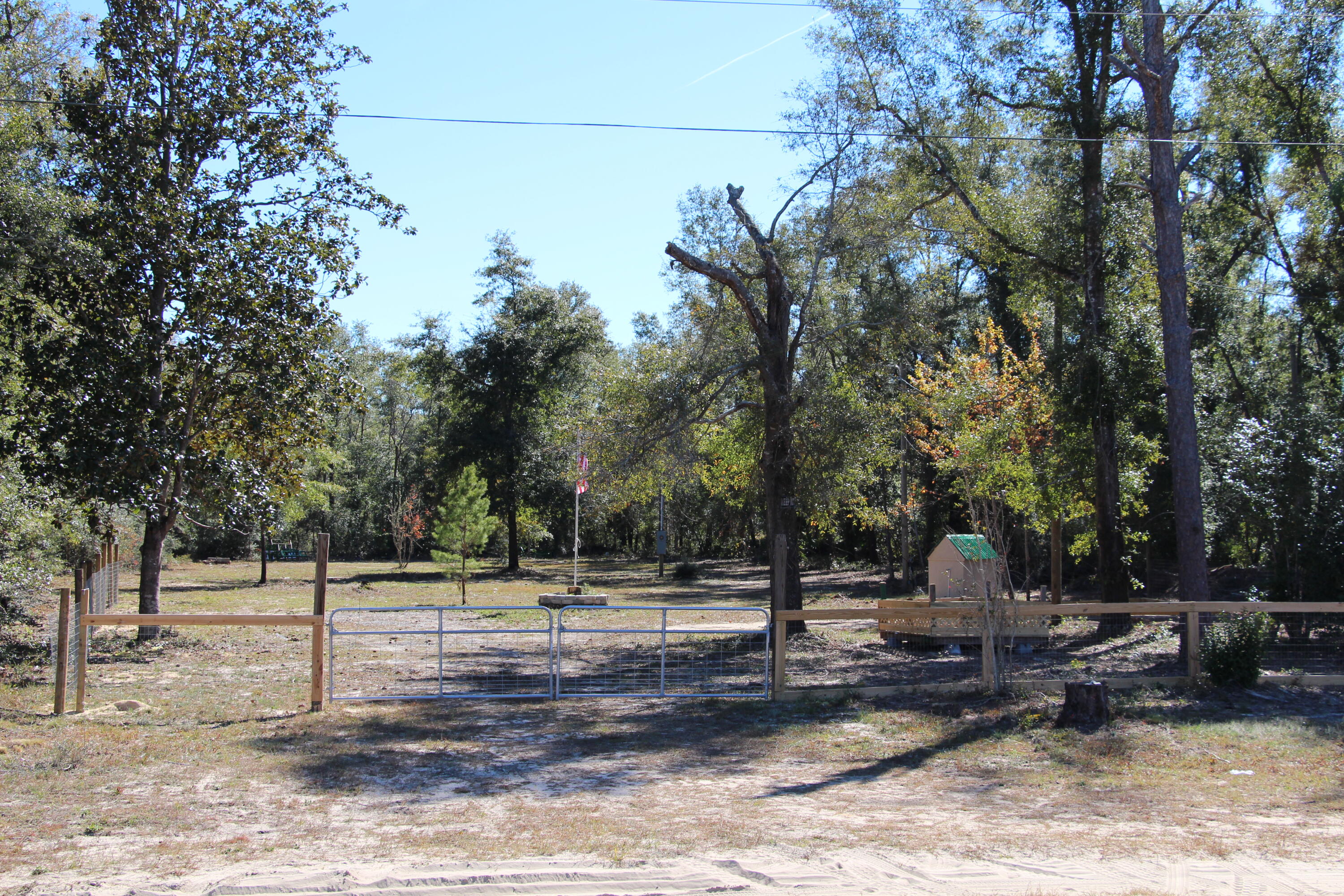 This parcel is approximately one acre cleared and ready for your new home. There is a parking pad near the front for an RV. It is partially fenced with a double gate and a single walk through gate. The parcel had a trailer on it in the past and it was removed. Septic and well do exist on the property however the owner does not know the condition of either. All measurements are approximate and should be confirmed by the buyer if important.