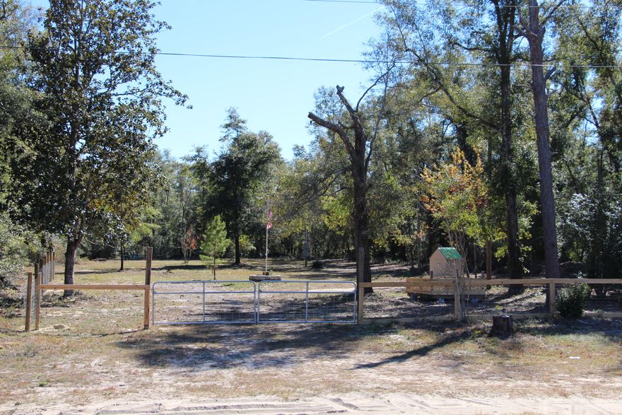 This parcel is approximately one acre cleared and ready for your new home.  There is a parking pad near the front for an RV. It is partially fenced with a double gate and a single walk through gate.  The parcel had a trailer on it in the past and it was removed.  Septic and well do exist on the property however the owner does not know the condition of either.  All measurements are approximate and should be confirmed by the buyer if important.