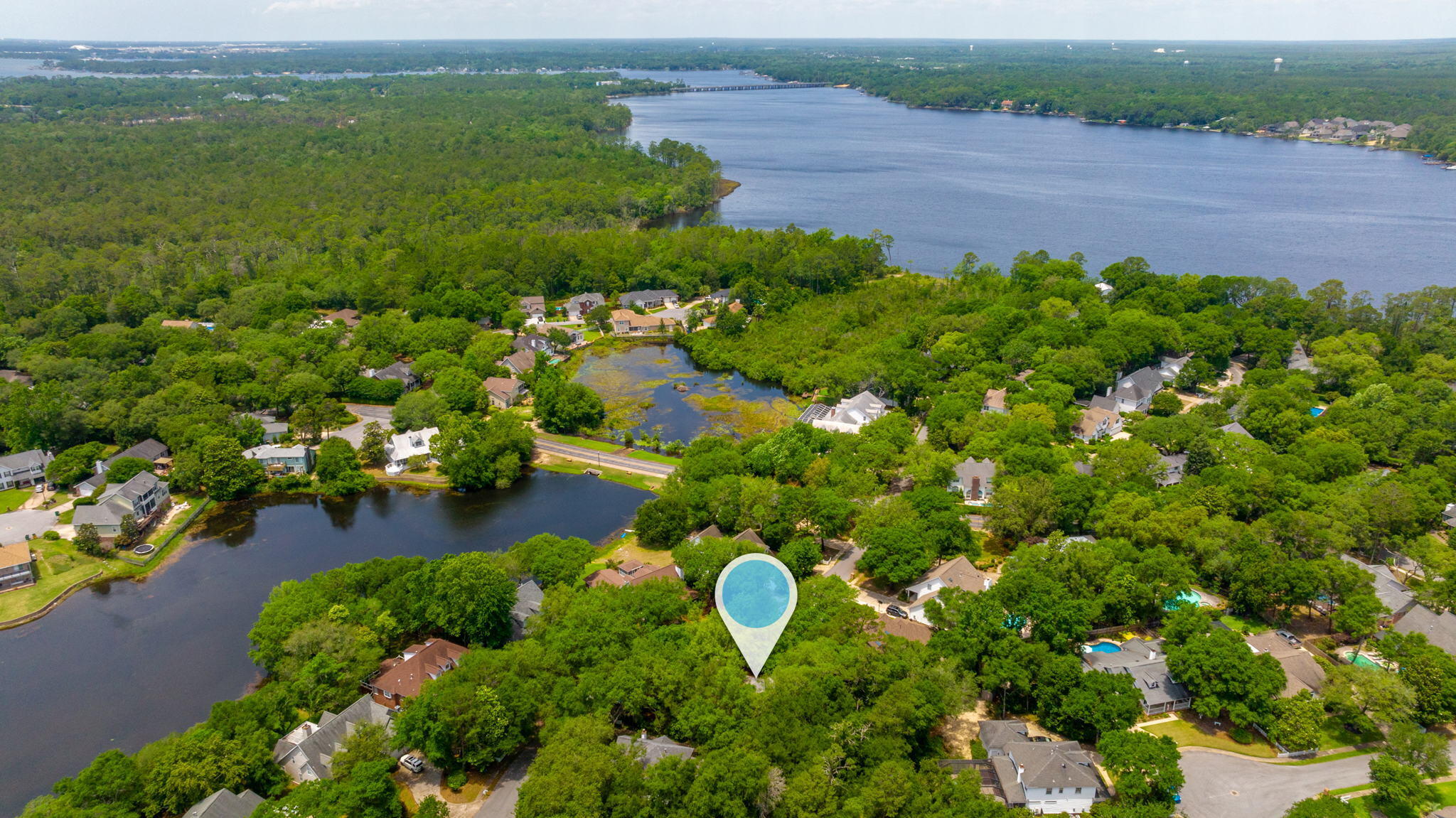 Stunning home in gated community of Bluewater Bay. You will love the newly painted walls and trim, new LPV flooring, and upgrades throughout. From crown molding to stunning chair railing, wainscoting, high ceilings, deep window casings and built in bookshelves- this home is unique and eye catching. Large living space flows into the huge kitchen with counter space and cabinets galore! Bedrooms all feature large closets, ceiling fans, carpet, and in suite access to the full bath. The loft space boasts built in bookshelves and overlooks the stunning staircase. Wrap around front porch, spacious back decks, and enormous backyard space. Even the garage features high ceilings and large garage door. Roof and HVAC are NEW!