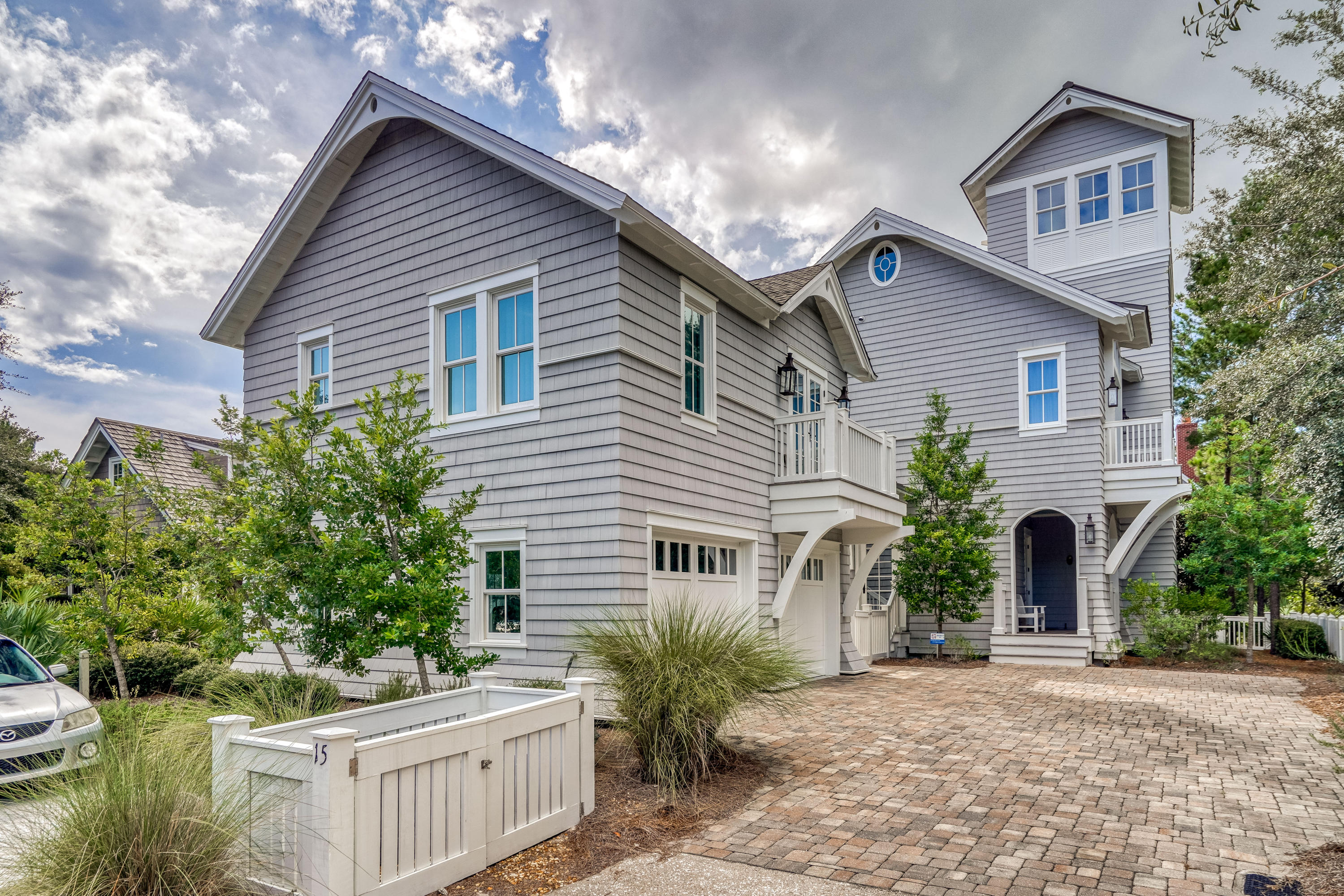 Crisp architectural lines and soothing neutrals create a peaceful coastal retreat at this 4BR/4BA/2 Half BA WaterSound Beach residence with a detached carriage home. A stunning collaboration between local experts Thurber Architecture PA, Dune Construction and Urban Grace Interiors, enjoy a central community location steps from the children's and dog park and only a short stroll or golf cart ride to the beach. Antique heart pine floors and shiplap walls are found throughout the home which features a reverse floor plan designed for gathering. The second level living and dining area are centered around a stately gas fireplace and feature vaulted shiplap ceilings. This light-filled space includes two sets of French doors that open to a spacious porch for extended living space. See ''More''