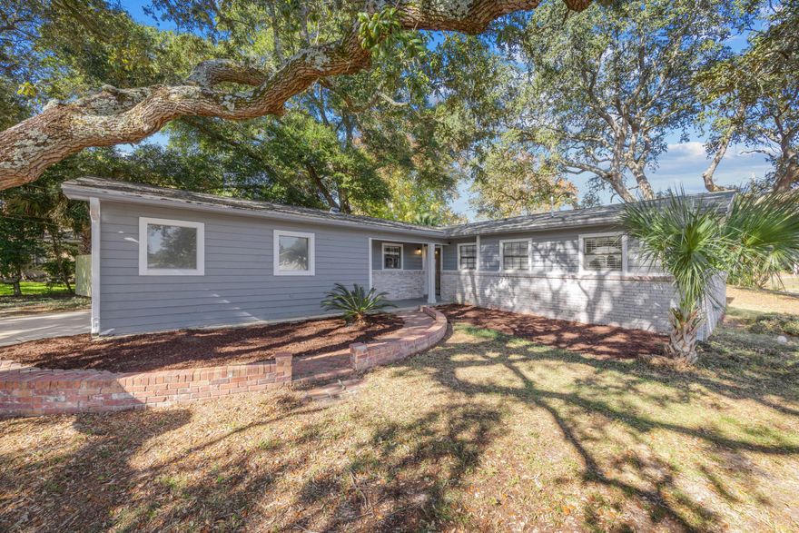 Major updates include a roof replacement in 2020, HVAC updates in 2020 & 2022, & exterior repainted in Nov 2025. Welcome to this charming 3-bedroom, 2-bathroom home situated on a large corner lot with mature trees in the heart of Fort Walton Beach just minutes from Eglin AFB and Hurlburt Field. Inside, the living area offers wood-look flooring throughout, recessed lighting, a stylish shiplap feature wall, and a cozy built-in shelving nook for added character and storage. The kitchen features stainless steel appliances, white quartz countertops, crown molding, and a convenient pantry closet, all flowing seamlessly into the dining area with double doors leading to the backyard. The primary suite includes a ceiling fan, double connected closet, and a beautifully updated bath with a glass and tile walk-in shower and barn door entry. Enjoy a privacy-fenced backyard with sections recently replaced complete with a covered patio, perfect for relaxing or entertaining. Additional highlights include a 2-car garage with laundry hookups and the convenience of a prime central location. This well-maintained home blends comfort, updates, and convenience ready for its next owner!