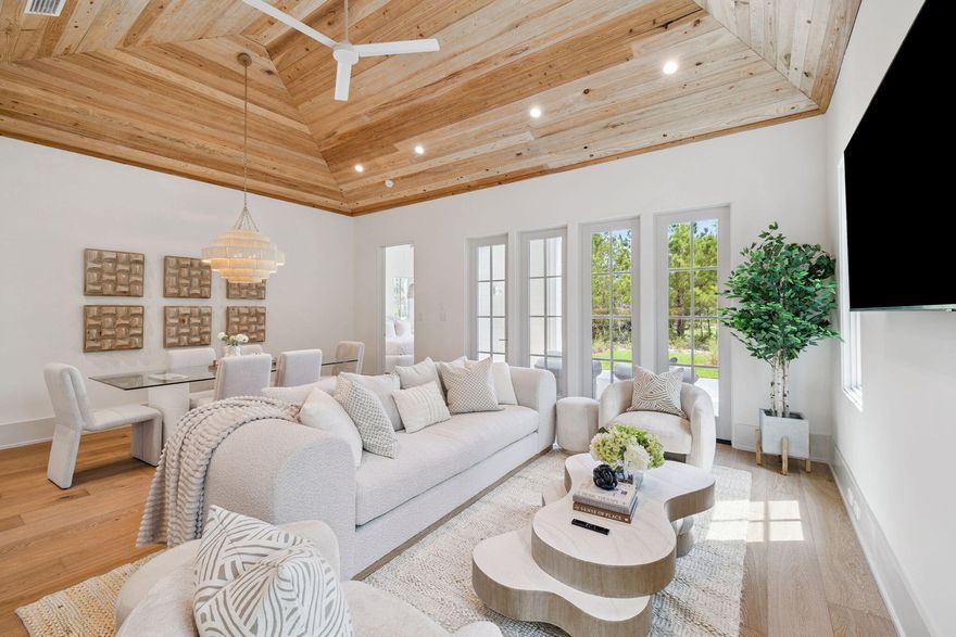 Life at 1576 Salamander Trail is about more than just the home. It is about waking up inside one of Northwest Florida's most desirable gated communities and enjoying a refined lifestyle surrounded by nature, golf, and coastal living. Located within Wild Heron, this new construction residence sits on a beautifully landscaped homesite with direct golf course frontage along the middle of the par 5 third hole of Shark's Tooth Golf Club, offering peaceful views and a true sense of resort living.Built by Focus Construction and thoughtfully designed by Coastal Architects, the home spans 2,477 square feet of heated and cooled living space with elevated finishes and intentional design throughout. Inside, 11 foot ceilings on the main level and vaulted cypress wood ceilings in both the living room and primary suite create volume and warmth. Expansive floor-to-ceiling windows flood the open living space with natural light while framing picturesque views of the lanai, backyard, and golf course for a seamless indoor-outdoor living experience.

The kitchen is both functional and beautiful, serving as the centerpiece for everyday living and entertaining. Premium Thermador appliances, custom shaker cabinetry, champagne accent hardware, and a large walk-in pantry with dedicated outlets make this space ideal for hosting and daily gatherings. Hardwood floors, solid-core doors, Delta Champagne Gold plumbing fixtures, and refined material selections continue throughout the home, reinforcing the quality of construction at every turn.

The first floor primary suite offers a private and tranquil retreat with a vaulted ceiling, spacious walk-in closet, and a spa-style en suite bath with rainfall shower and designer tile that extends to the ceiling. An additional first-floor bedroom with its own en suite bath provides flexibility for guests or multigenerational living. Upstairs, two additional bedrooms, a full bath, and a loft-style common area complete the home's thoughtful layout, providing comfortable space for family and visitors.

Outdoor living is equally impressive and perfectly suited for coastal entertaining. The covered porch features a full summer kitchen with a grill, refrigerator, ice maker, and sink, creating an ideal setting for dining, relaxing, and enjoying golf-course sunsets. The exterior architecture pairs timeless Hardie board siding with light brick accents, and the two-car garage is pre-wired for an electric vehicle charging station.

Wild Heron itself is a 734 acre gated neighborhood along the shores of Lake Powell, the largest coastal dune lake in Florida. Residents enjoy a private lifestyle with access to a community pool, fitness center, boathouse, and miles of scenic walking trails. For golf enthusiasts, Shark's Tooth Golf Club sits within the community, and nearby Watersound Club has added The Third course designed by Davis Love III. Combined with Camp Creek Golf Club, members now have access to 54 holes of championship golf. Memberships are available separately from HOA dues. The community board, in partnership with St. Joe, has also approved a future private cart gate with a dedicated path for Wild Heron owners and Watersound Club members, providing direct access to Watersound Parkway and 30A.

This home offers an exceptional blend of luxury, comfort, golf front living, and access to one of the Emerald Coast's most sought-after communities. Whether used as a primary residence or second home, this is a property designed for everyday enjoyment, effortless entertaining, and lasting memories.