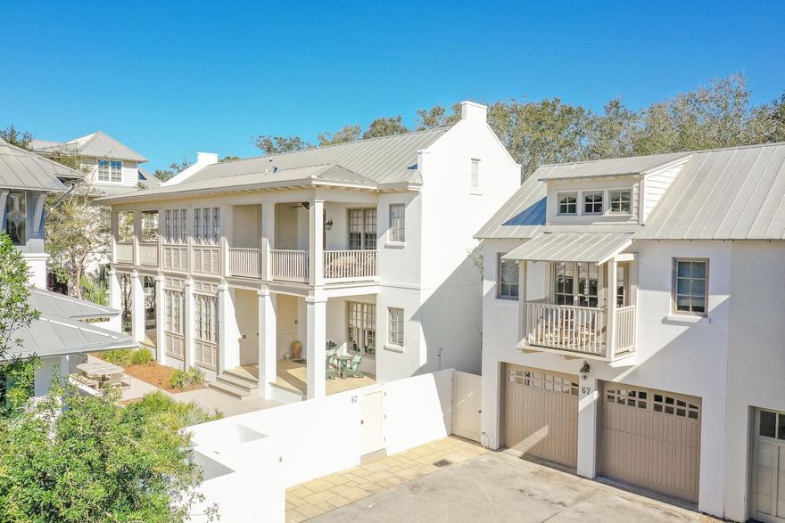South of Scenic 30-A in the community of Rosemary Beach, this newly renovated Charleston courtyard home proudly sits on a quiet cul-de-sac. Protected by a white stucco perimeter wall, this wide parcel opens directly onto serene Boardwalk E.Artfully designed by Looney Ricks Kiss, 67 Dunmore Town Lane is graced by majestic parapets and an abundance of private spacious porches. It offers a wonderfully crafted floor plan on two levels providing easy living for families and their guests. An abundance of large windows and spacious porches grace this stunning 5 bedroom, 5 1/2 bath that includes a separate carriage house residence.Newly custom furnished in a Rustic Modern style with a coastal flair featuring clean lines of whites, grays, and beiges.