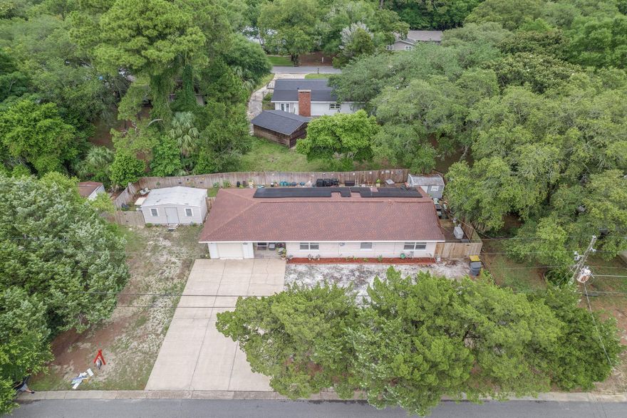 This home sits on a LARGE lot and is located in a quiet, close-knit neighborhood just minutes from the water,101 Elm Ave SE offers a practical and thoughtfully situated home in the heart of Fort Walton Beach. Families will appreciate the proximity to Elliott Point Elementary School, while active duty and DOD personnel benefit from being just 6.5 miles to both Eglin AFB and Hurlburt Field main gates.  Located less than a mile from Bay Drive Water Access and only minutes from Okaloosa Island, Downtown Fort Walton Beach, and a variety of dining and shopping options, this home offers both comfort and convenience. Featuring a 2018 roof, 2022 HVAC system, and a 2023 Generac generator, ensures peace of mind during storm season. 2021 & 2022 Solar panels and 2024 spray insulation in the attic support energy efficiency year-round. Inside, a large foyer welcomes you into the living area, where laminate wood flooring was added in 2018 for easy maintenance and style. The front windows were tinted in 2021 for added privacy and energy savings. The primary bedroom features a new spacious walk-in closet (2024) and additional secondary closet space, offering generous storage. An outdoor enclosed laundry room provides more storage, and two large backyard sheds expand your options for tools or equipment as well as the single car garage. The open patio area in the backyard is ideal for gatherings or quiet evenings outside. This home blends functionality, efficiency, and locationideal for those looking to live near the coast without sacrificing everyday convenience. Schedule your private showing today! 