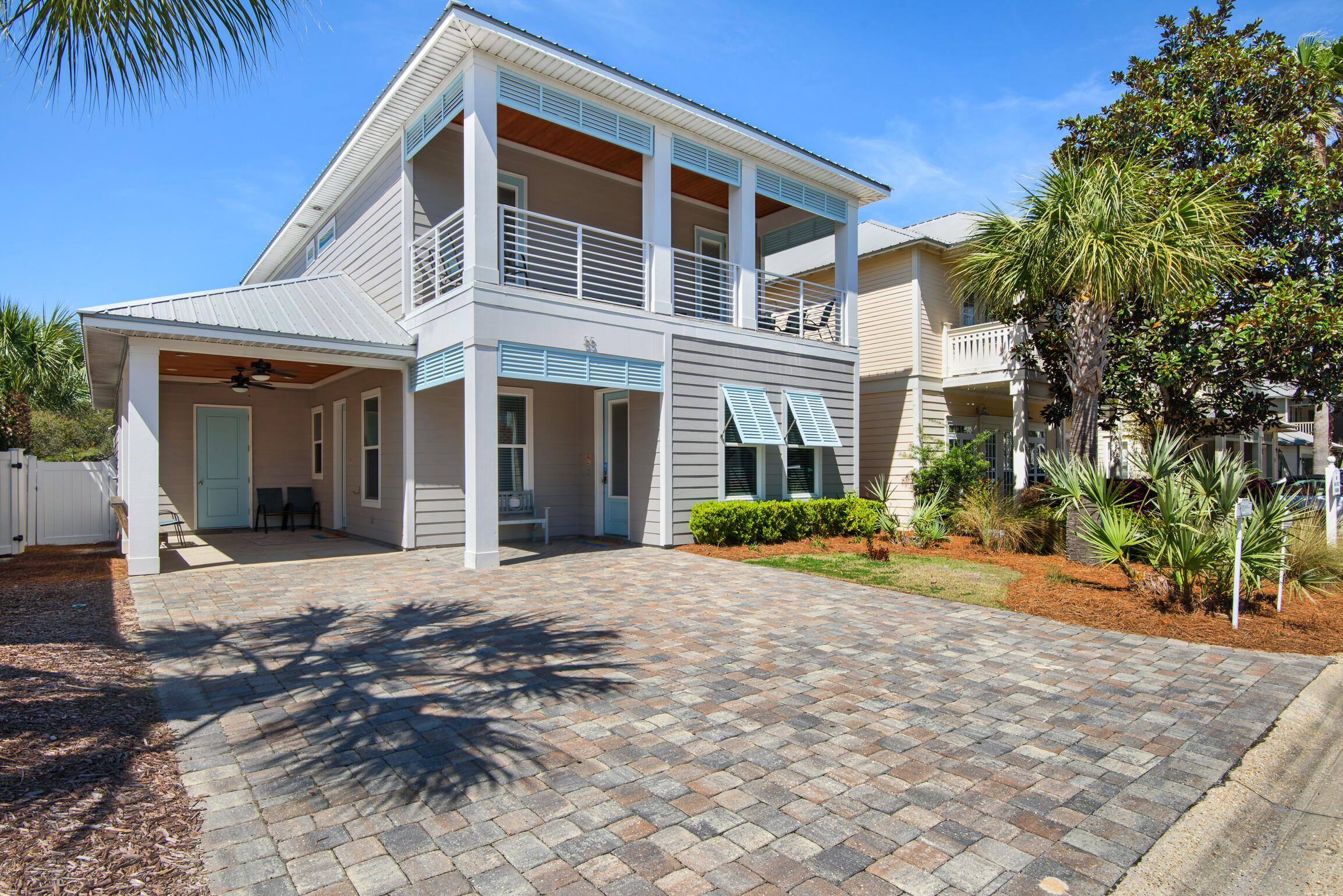 Coastal Luxury Just Steps from the Beach!Fall in love with this furnished turnkey 4BR/3.5BA custom beach retreat in the coveted gated community of Emerald Waters Village! Built in 2019 and thoughtfully designed for comfort and style, with 2 master suites (one on each floor), 2 spacious living areas, soaring 10' ceilings, crown molding and a well appointed kitchen with stainless steel appliances--including a beverage center and under-counter ice maker. With room to sleep 12, it's perfect for large families or a vacation rental. You'll love the dual laundry rooms, a tankless water heater, covered front and second floor porches and fenced yard. The carport includes a large storage area & a private owner closet. Enjoy the 2 sparkling community pools & deeded beach access!