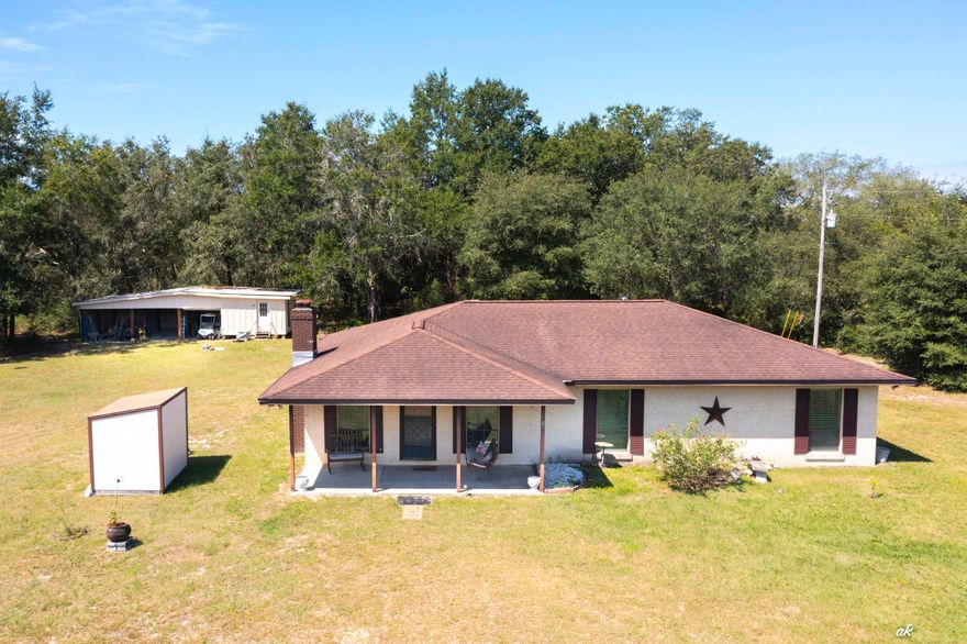 Looking for space and privacy but still want to be close to town? This 3-bedroom, 2-bath home sits on 1 cleared acre with 3 more acres of untouched land--all fenced and ready for whatever you have in mind. You'll love relaxing on the front porch swing or the screened back porch, and there's even some blueberry bushes for a little extra charm. Inside, the kitchen has quartz counters (2022) and all new appliances (2022). Windows were replaced in 2023, HVAC updated in 2012, and a walk-in bathtub added in 2019. The home also comes with a Culligan water system (owned, not leased). Cozy up to the wood-burning fireplace, which currently has an electric insert, and enjoy the easy-care laminate and vinyl flooring throughout. Property includes a 14' x 18' shop with three open baysperfect for storing vehicles, boats, tractors, and more. Built of block with stucco, this home is solid and move-in ready. You get the best of both worldspeaceful country living with shopping and restaurants just minutes away. All measurements are approximate; buyer to verify if important.