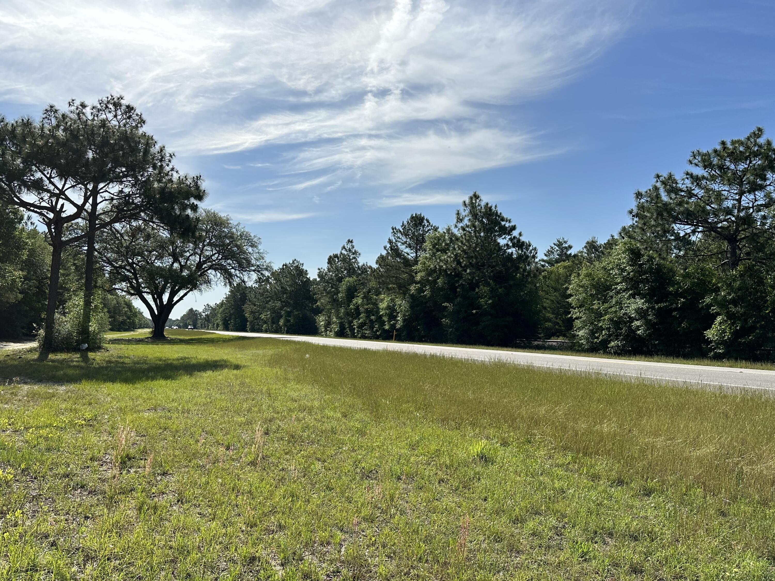 LOCATION LOCATION!!!!Here is your perfect location for you new home! Bring your build plans today!This level lot features beautiful live oak trees and has plenty of US Highway 90 Road frontage giving easy access to Hwy 331, hwy 83 and I-10. Giving multiple access to local grocery stores, shopping centers and various beaches.Zoned as Rural Residential