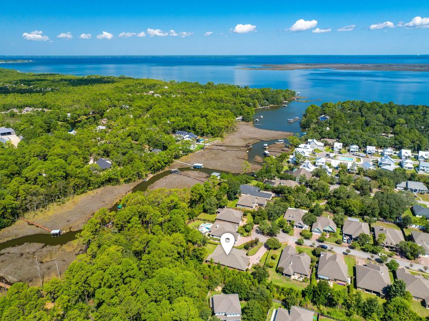 Waterfront living at its best! This 5-bedroom, 3-bath home with office/study and formal dining sits on 82.5 feet of Mussett Bayou and comes complete with its own pier, dock, and boat slip--offering direct access to Choctawhatchee Bay via Hogtown Bayou. Whether you're an avid boater, fisherman, or simply love relaxing by the water, this property delivers the lifestyle you've been dreaming of.Located at the back of a quiet gated cul-de-sac in Mussett Bayou Estates, this sought-after McKenzie floor plan by D.R. Horton backs up to a natural preserve, providing both privacy and serene views. Inside, the open layout is perfect for entertaining, with a gourmet kitchen featuring granite countertops, stainless steel appliances, mahogany cabinets, an island with wine cooler, and a hop-up breakfast barall flowing seamlessly into the great room and breakfast area. Large windows and double-tray ceilings fill the space with natural light, while sliding doors open to a covered, screened lanai overlooking the backyard and water.

The split-bedroom design offers comfort and privacy, with the Master Suite tucked away at the rear of the home. Here, you'll enjoy direct lanai access, a spa-like bath with jetted garden tub, oversized tiled shower, dual vanities, and a huge walk-in closet.

Additional highlights include hardwood floors, upgraded lighting, tile in all wet areas, a finished two-car garage with attic storage, Fabric Shield hurricane protection, and lush landscaping with exotic trees and shrubs.

From quiet mornings on the dock to sunset cruises on the bay, this home blends elegant interiors with an unbeatable waterfront lifestyle.