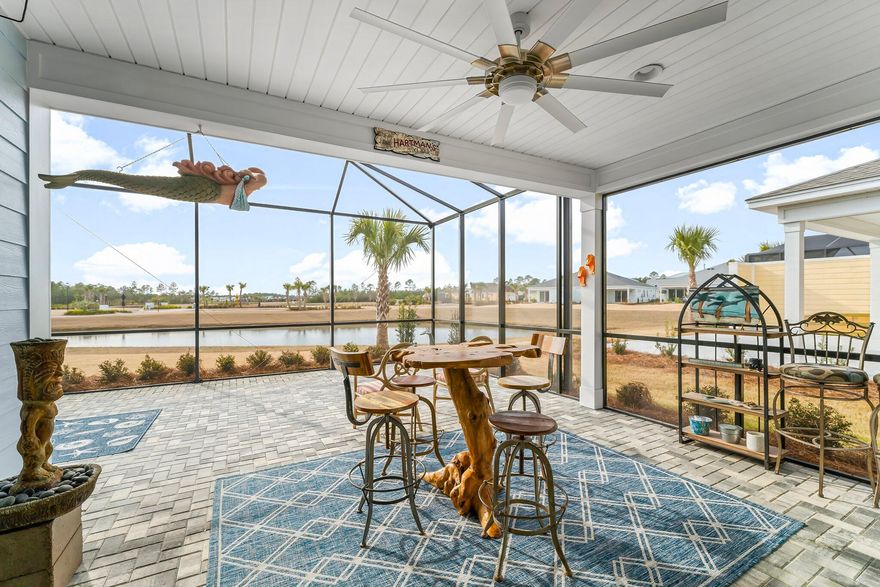 Discover your dream retreat at the exquisite Tortola Villa, Furnished (with exclusions) and complete with a luxurious spa that conveys overlooking a gorgeous pond view in the 55+  community of Latitude Margaritaville Watersound in Panama City Beach!  This exceptional villa is unique, featuring not just two spacious bedroom suites, but also a convenient powder room and a versatile flex room, all within an expansive 1,743 sqft layout. Revel in the numerous custom upgrades that elevate this home beyond a typical new build, including stunning Luxury Vinyl Plank flooring throughout the common areas, bedrooms, and powder room, plus a stylish ocean floor epoxy finish in the garage with added shelving for convenience. Culinary enthusiasts will adore the chef's kitchen, outfitted with an upgraded appliance package, 42" cabinets with under cabinet lighting, elegant quartz countertops, and a wine/beverage coolerperfect for savoring your favorite libations while enjoying picturesque pond views. After a delightful meal, unwind on the extended pavered lanai, where you can indulge in the spa and witness breathtaking evening sunsets. Cozy up by the fireplace before retreating to the master suite, featuring a seamless shower designed for ultimate relaxation. With all this luxury at your fingertips, you're guaranteed the best night's sleep as you dream of tomorrow's adventures in Margaritaville. Whether it's soaking up live music every day, swimming in the resort-style Oasis pool, dining at Bar & Chill, or participating in countless fitness classes and events organized by the dedicated Lifestyle staff, Tortola Villa is your gateway to a vibrant and fulfilling lifestyle. Don't miss out on this extraordinary opportunityyour paradise awaits!