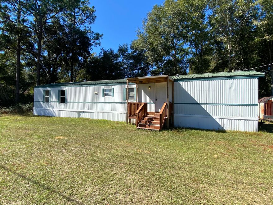 Country Living.  Local attractions in the area are: Baker Sports Complex and Baker Rec Center.  Hurry this charming two bedroom won't last long.  This open floor plan seems roomy with its open living area.  Livingroom   flows into the kitchen.  Large breakfast bar with plenty of room.  Bedrooms are on each end of the mobile home.   Nice yard with storage shed.