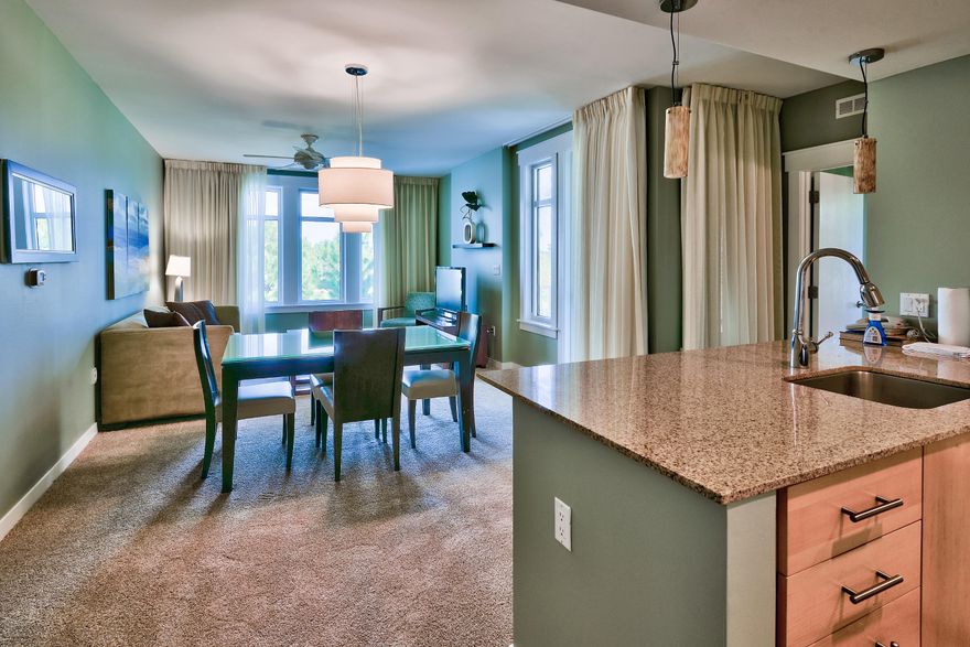 Beautiful lake and golf course views abound from the private balcony in this one bedroom second floor condominium. Open plan living and dining area with plenty of space for entertaining includes a queen sleeper sofa for extra guests. The fully equipped kitchen features granite counters and breakfast bar. The spacious bedroom boasts an en suite bathroom with double vanity. Property is offered fully furnished and ready to enjoy and/or rent. Elation owners also enjoy access to the Solstice Club, a private amenity on the bay for owners and their guests with barbecue facilities, a screened porch and kitchen with restrooms. There is also a storage area for bikes, beach toys etc.