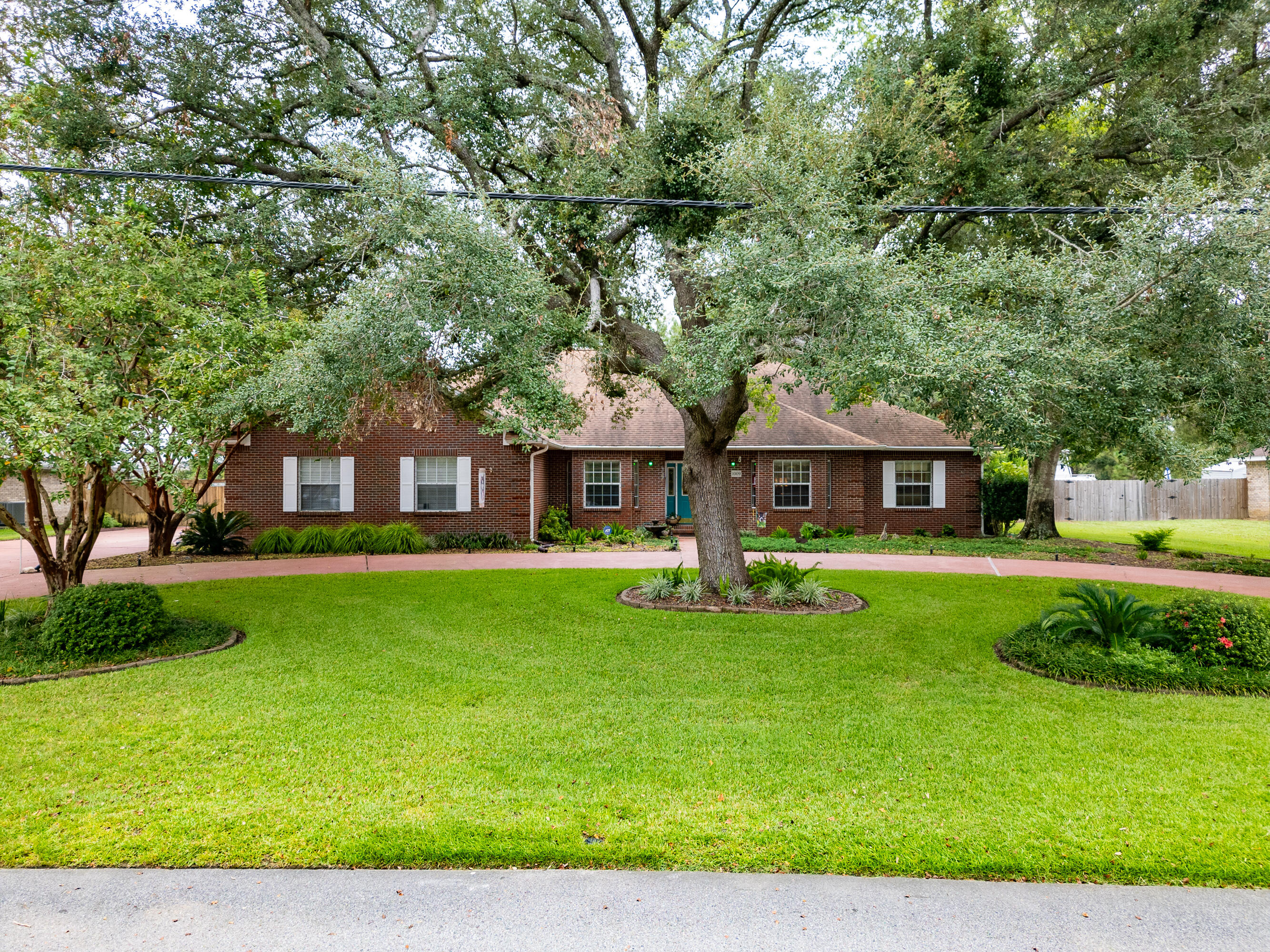 SPRAWLING BRICK ESTATE, SURROUNDED BY ENGLISH-STYLE GARDENS, NOW AVAILABLE.. and this home sits directly across from Shoal River Lakes!!!Welcome to 1009 Shoal River Drive! This 4 BR/2 1/2 Bath floorplan boasts ''grand living'' and ''thoughtful design''.From colonial brick masonry with quoin corner embellishments.. to a circular drive entry accented by lush greenery.. this 2600-PLUS square foot home offers upgrades outside and in.Step through leaded-glass doors, and you'll see upgraded moldings and trim.. neutral paint.. recessed lighting.. pocket doors.. and BEAUTIFUL HAWAIIAN KOA LVP!French doors, on the left, lead you to the formal dining room with tray ceiling and recessed crown. (Continued) French doors, on the right, lead you to the 4th bedroom, which was recently converted into an office.
The living room is grand with vaulted ceilings.. and a colonial brick fireplace!
The GOURMET KITCHEN features custom oak cabinetry with under cabinet lighting and glass doors.. HIGH-END GRANITE.. FULGOR MILANO DOUBLE OVEN.. GAS COOKTOP.. TWO PANTRIES.. COFFEE BAR.. AND SEPARATE BREAKFAST AREA.
The master suite is impressive with tray ceiling, his/hers walk-in closets, private patio access, large windows and more of the "Hawaiian Koa" luxury vinyl plank flooring.
The master bath is grand in scale... with a deluxe-sized garden soaker tub with plant ledge, and a 2-person walk-in shower with glass enclosure. There's also 2 linen closets.. one with upper cabinet storage.. and a separate bidet!
The remaining bedrooms are spacious with generously-sized closets. The guest bath offers tiled counters.. standard tub/shower combination.. and untapped equity for the savvy buyer.
A big house needs a big laundry room and this one delivers! Check out the "Hall of Storage" leading to the KENMORE WASHER/DRYER that will convey! The owners also added a utility sink with counter and additional cabinetry.
The sunroom offers views of the english-style gardens and leads to a covered patio with BRAND NEW CONCRETE COATING.. and a 17 1/2 foot SUNSETTER RETRACTABLE AWNING!
The privacy-fenced backyard offers numerous gardens, brand new rainbird sprinkler system, gardening shed, butterfly garden, fountain, additional parking pad and lots of space (.46 ACRE).
The open patio provides room for backyard entertaining and is wired for hot tub hookup.
Other notable mentions: new septic drainfield, Storm Stopper Shutters, new roof in 2018 and new landcape lighting for the front yard. Check out the landscape lighting at night! #STUNNING
COUNTY TAXES AND QUICK COMMUTE TO THE BASE! What are you waiting for? Make an offer today.