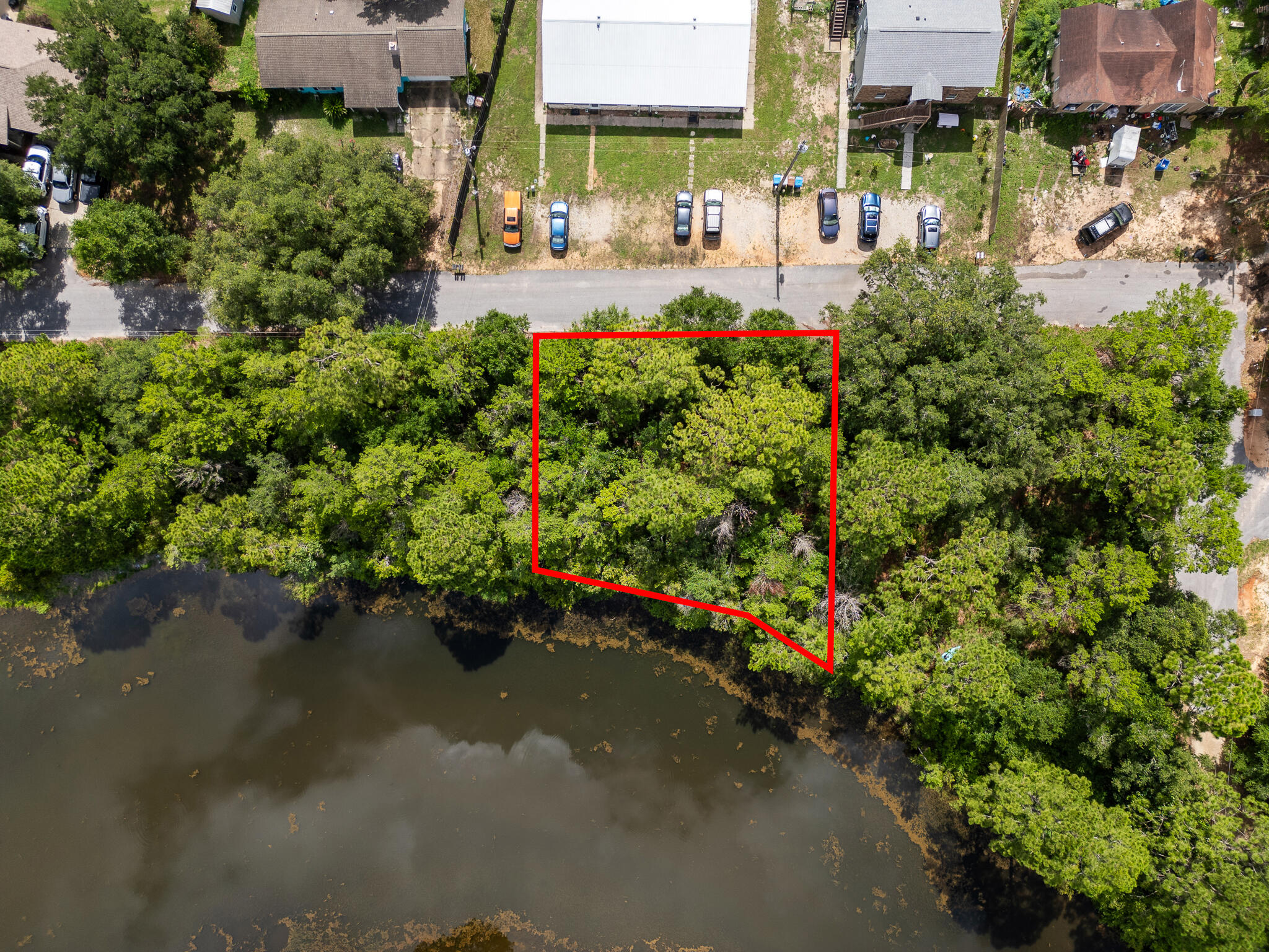 Own your personal little piece of lakefront living, ideally situated just off East Bay Blvd and minutes from Hurlburt Field and white sand Navarre beaches. Whether you want to custom build or just need a little space to set up, this valuable property, just under 1/4 acre, is ready for your creativity and custom home design.