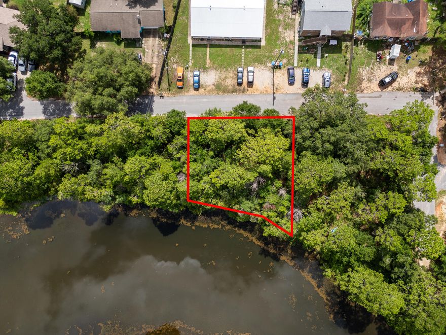 Own your personal little piece of lakefront living, ideally situated just off East Bay Blvd and minutes from Hurlburt Field and white sand Navarre beaches. Whether you want to custom build or just need a little space to set up, this valuable property, just under 1/4 acre, is ready for your creativity and custom home design.