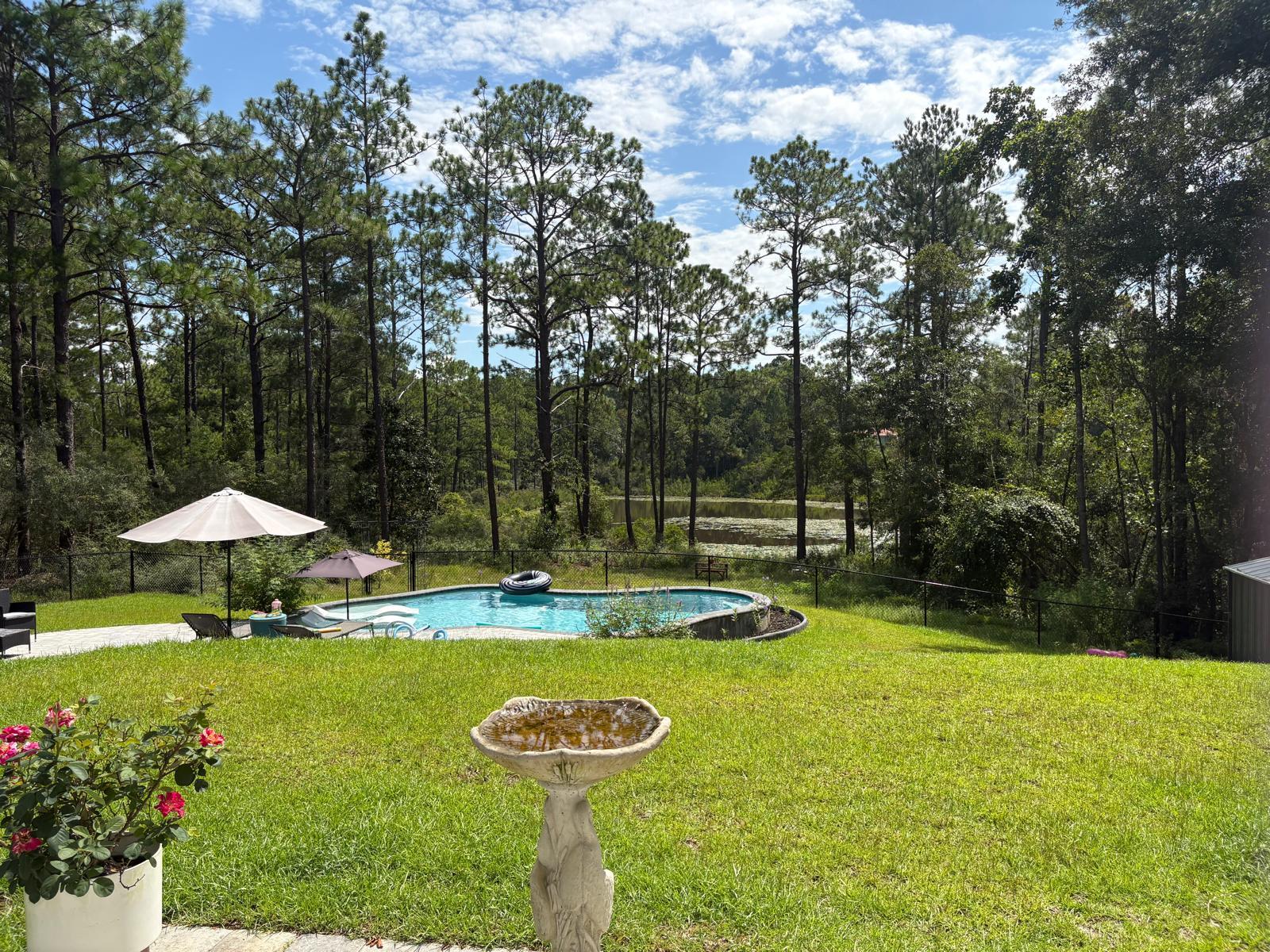 Backyard Bliss Meets Country Charm!Welcome to 389 Quail Ridge Rd, a stunning 1-acre lakefront retreat that perfectly blends country charm and modern comfort. This beautifully designed 4-bedroom, 3-bath home--built in 2024-- offers the ideal combination of space, privacy, and recreation, whether you're seeking a peaceful full-time residence or a high-potential vacation rental. Since ownership, the seller has invested approximately $97,000 in improvements and upgrades!Two words describe this property perfectly: PRIVATE OASIS. Step outside and you'll see why--your backyard paradise features a sparkling pool (a rare find in DeFuniak Springs!), a cozy firepit patio, and an expansive yard with a serene view of the lake. It's an entertainer's dream, ideal for family reunions, weekend gatherings, or simply unwinding in peaceful surroundings.
Adding to its rustic appeal, the property includes an auxiliary building currently used as a chicken coop, bringing a touch of country living while keeping you close to town for everyday convenience. The same structure (sold as-is) can easily be repurposed into a workshop, storage space, creative studio, or she-shed, offering endless versatility. The property also comes complete with hardwired security cameras for added peace of mind.
Inside, you'll find thoughtful upgrades throughout, including energy-efficient LED lighting and remote-controlled ceiling fans upstairs. The open layout maximizes natural light and captures a beautiful view of the lake, creating a welcoming, comfortable space for everyday living or entertaining guests.
With no HOA, you have the freedom to enjoy the property your way whether as a family home, relaxing retreat, or income-producing vacation rental, the possibilities are endless.
Highlights & Improvements:
1-acre lakefront property - No HOA or Restrictions!
Built in 2024 | 4 bedrooms, 3 bathrooms
Energy-efficient LED lighting & remote-controlled ceiling fans
Private pool with patio & firepit overlooking the lake
Auxiliary building/chicken coop with flexible use (workshop, studio, storage)
Gutters with rain barrels under each downspout
Yard clearing, mulching, and new sod
Fence installation for privacy
Additional land enhancement & maintenance
Installation of shower doors
Hardwired security cameras
Ideally located just off US Highway 331, this home provides easy access to both Downtown DeFuniak Springs and Downtown Freeport (10 minutes each), as well as a direct route to the white sandy beaches of the Emerald Coast just 30 minutes away. Nearby I-10 also offers quick connections for traveling beyond the area.