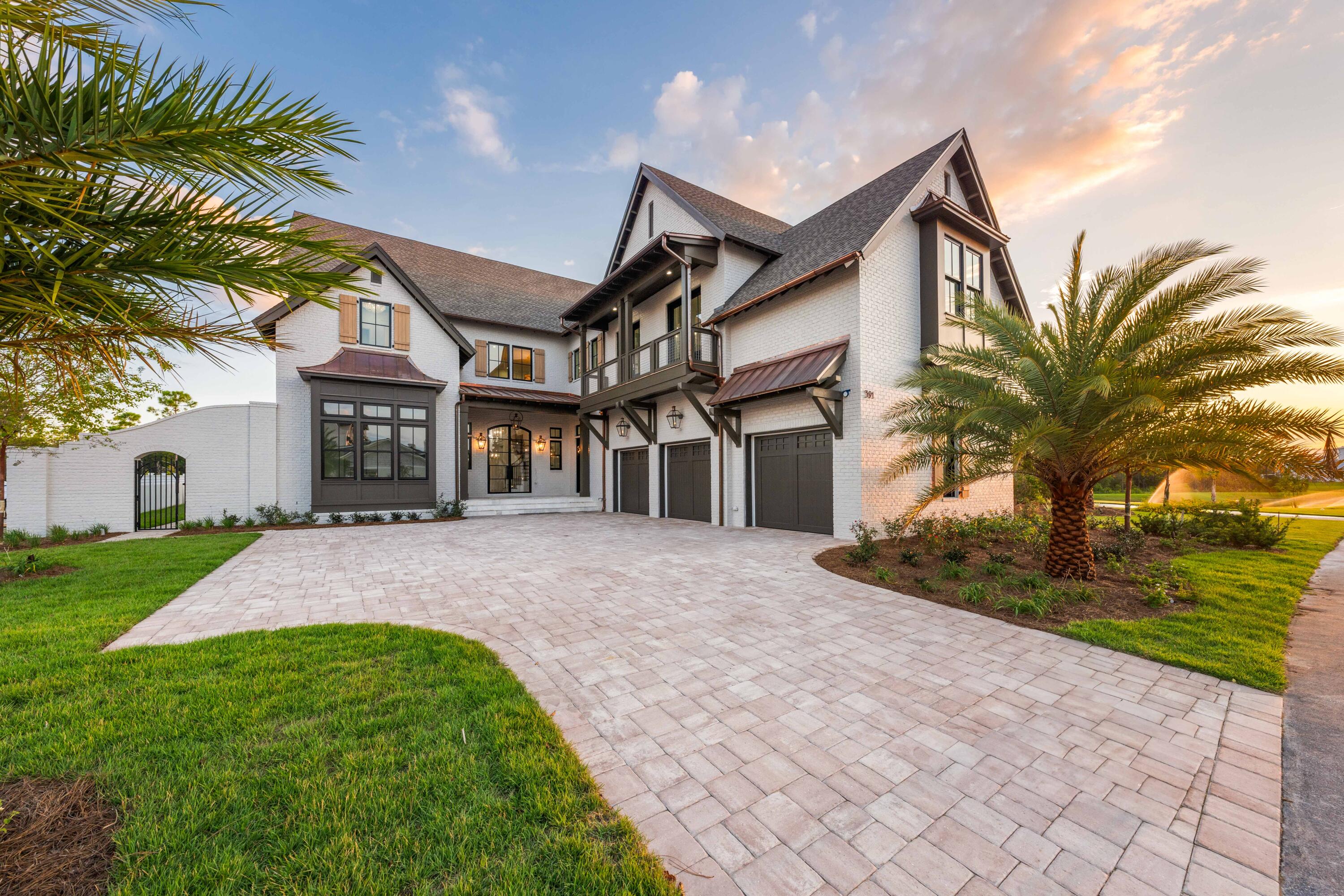 A stately ambiance greets you at 391 Golfridge Drive from the moment you cross the elegant brick threshold. Located in the distinguished Watersound Camp Creek community, this newly constructed residence boasts 5,450 square feet of intricately designed spaces with a 4BR/4.5BA primary home, a 1BR/1BA carriage home atop the 3-car garage, an elevator, and an expansive outdoor entertaining area with private pool, spa, and cabana with fireplace.  Glass-paned double doors open to a welcoming foyer highlighted by beautiful millwork, a grand curved staircase, and an arched threshold leading to the spacious living and dining areas. Details such as coffered and shiplap ceilings, custom built-ins, and stunning designer lighting fixtures create beautiful and welcoming spaces designed for both luxury