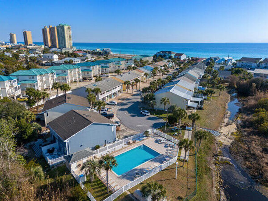 BRING AN OFFER! END UNIT! Come see this in person!! Discover your dream getaway at this stunning end-unit townhome in beautiful Panama City Beach! With 2 huge bedrooms, a newly remodeled interior, and a huge back porch perfect for soaking up the sun, this fully furnished gem is ready for you to move in. Enjoy the community pool and envision the rental potential if you choose to share this paradise. 50K IN RENTAL POTENTIAL! WOW! Ask for A CASH FLOW SHEET! Don't miss out on this opportunity! Call TODAY for a showing! EASY SHOW!