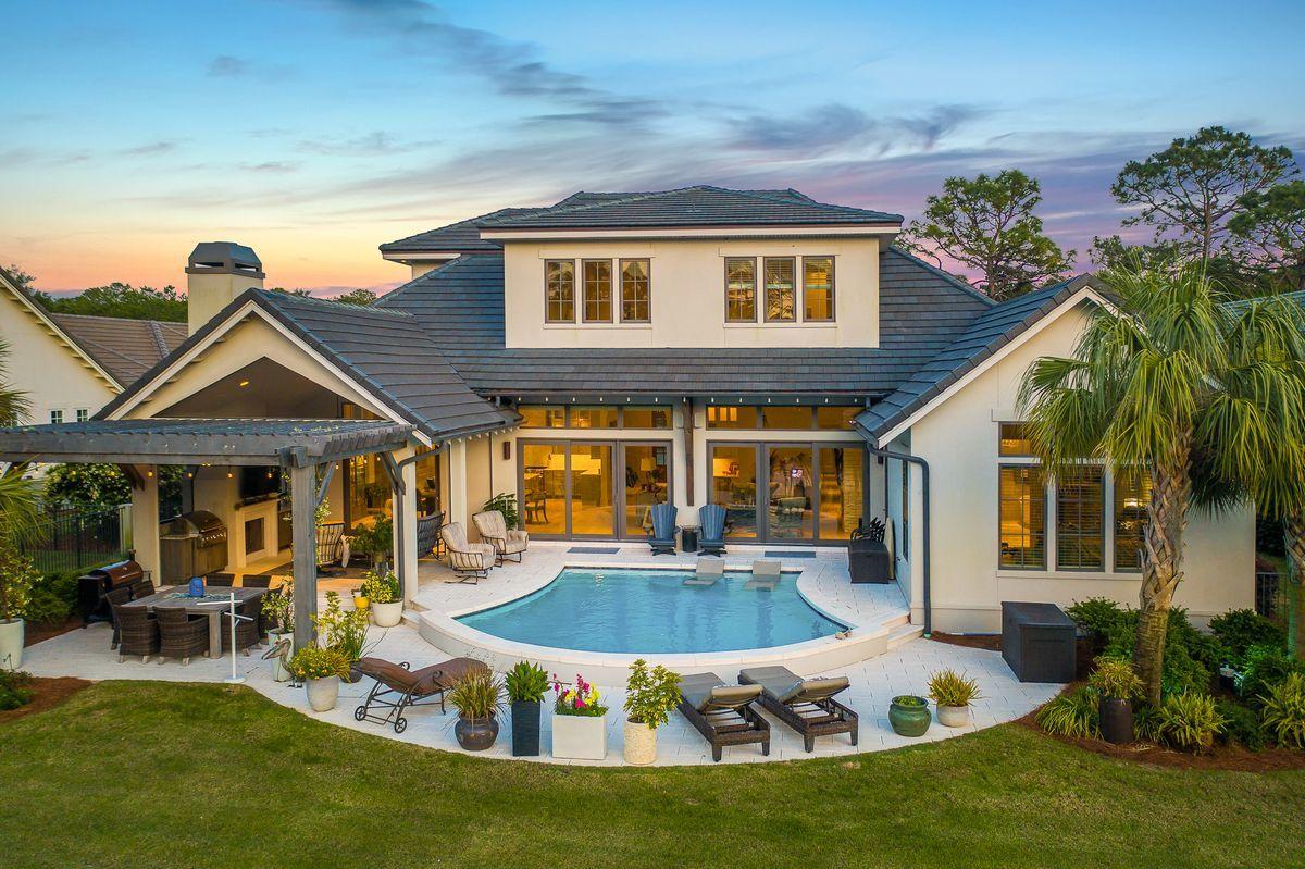 Modern elegance meets artful coastal contemporary design in this extraordinary lakefront residence ideally located in the prestigious gated community of Regatta Bay. Completed in 2018, this finely appointed home offers striking architectural detail juxtaposed coastal interior design masterfully configured featuring four spacious bedroom suites, four and one half bathrooms as well as a spacious open floor plan characterized by expansive single-floor living & gorgeous designer appointments throughout.