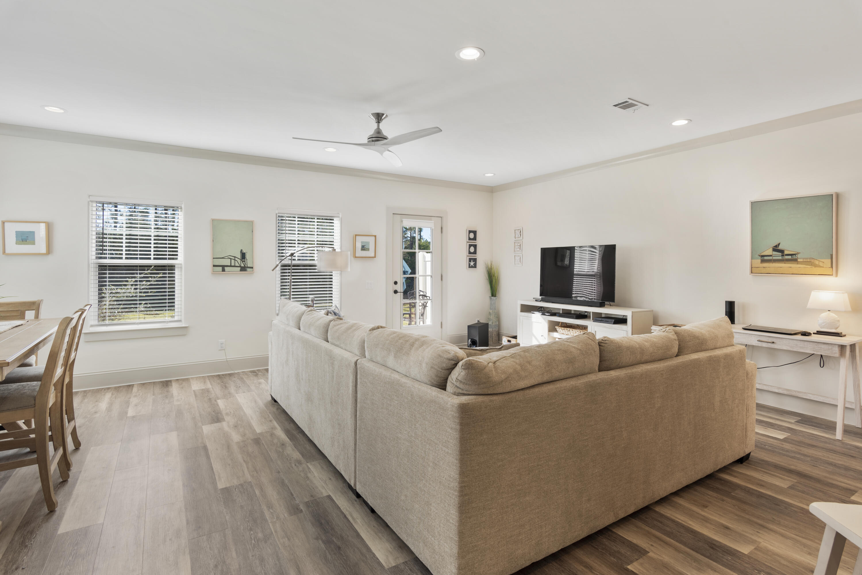 Don't miss this opportunity to own a quality built townhome in a small and quiet subdivision on the south side of Scenic 30A! Step inside to this spacious corner unit and into a long list of upgrades and features, the first being 9 foot ceilings on each of the two floors. The ground level kitchen boasts granite countertops, stainless steel appliances, upgraded lighting, and gorgeous white and bright soft close cabinetry & drawers. Sit at the kitchen island bar and overlook a spacious and comfortable living space. Luxury vinyl plank flooring flows throughout the home and to the second story. Upstairs are three bedrooms; a large master suite with an en suite bathroom with an oversized walk in shower and two guest suites, each spacious and well lit.