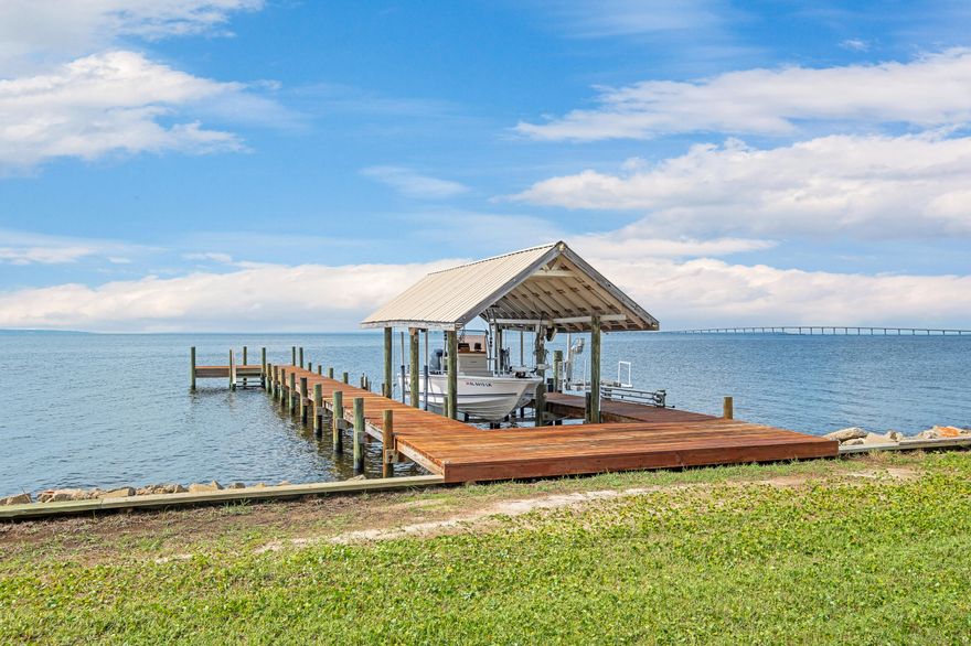 Discover the epitome of bayfront luxury in the serene Whisper Bay community! This beautiful 5-bedroom home, situated on an expansive .65-acre lot, offers 98 feet of stunning waterfront property.Elegance meets practicality in the kitchen with luxurious marble countertops, and guests will feel right at home in the exceptional guest/mother-in-law suite. The home is equipped with a whole house generator, ensuring comfort and security during any weather.Boating enthusiasts will appreciate the boatlift and WaveRunner lift, and the back of the home is fortified with hurricane shutters. Enjoy the peace of mind of a new roof installed in 2021 and benefit from the advanced Culligan water system.