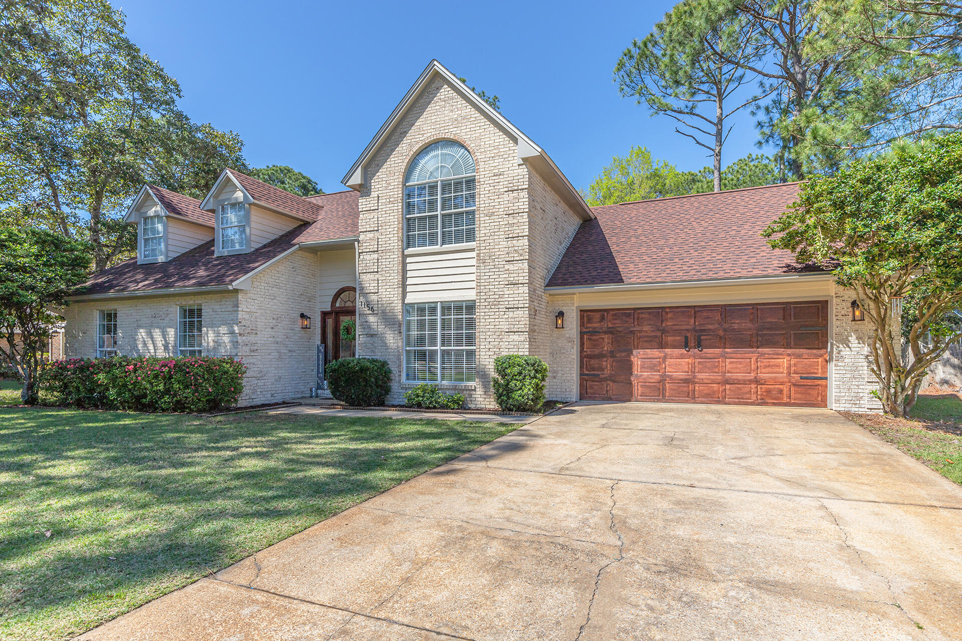 STUNNING RENOVATED Bluewater Bay golf course home located in St Andrews Village with panoramic views of the Bay Course at Bluewater Bay Resort.Every inch of this 4 bed/ 2.5 bath home has been immaculately maintained. The property features updates throughout, soft neutral color scheme, updated kitchen with white cabinetry, granite countertops, stainless steel appliances and a breakfast nook overlooking the backyard/golf course. Spacious living room with vaulted ceilings, built-in bookcases, and a cozy brick fireplace. Off the living room is the newly renovated four seasons room which offers gorgeous views and an abundance of natural light from the windows and skylights. First floor primary bedroom with tranquil en-suite bathroom featuring his/hers walk-in closets, modern double vanity,