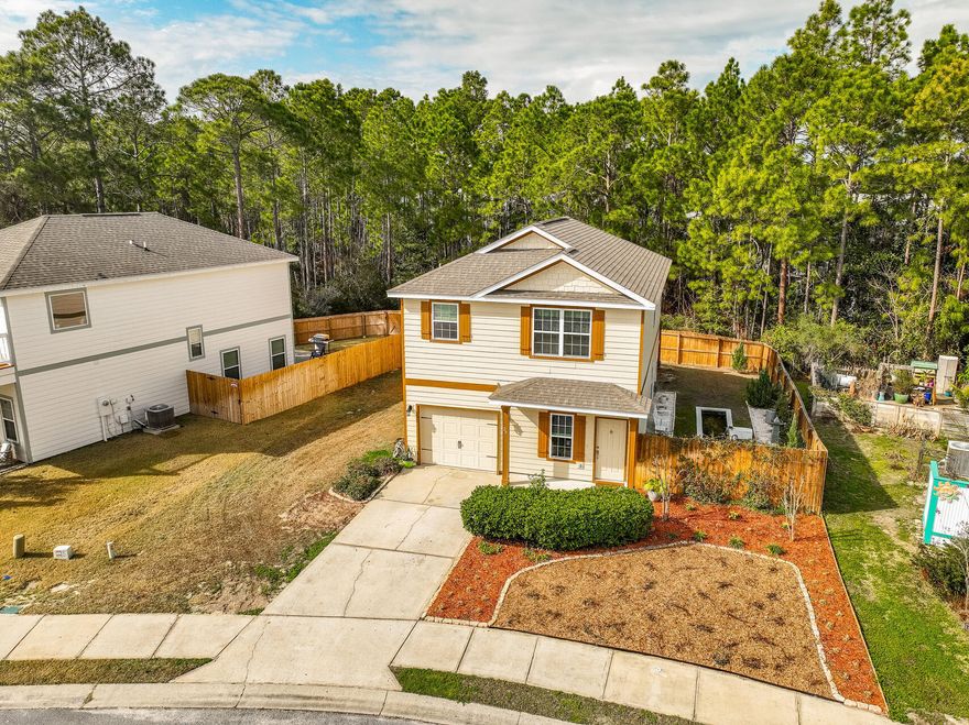 Step into this stunning coastal-style home nestled in the private community of Topsail Walk. Ideally situated just under half a mile from public bay access with two boat ramps and only minutes from the beach, Sacred Heart Hospital, and Grand Boulevard's premier shopping and dining, this home seamlessly blends convenience with coastal charm.Designed for effortless entertaining, the open and spacious floor plan flows seamlessly from indoors to out. The extended deck, illuminated by charming string lights, creates a warm and inviting ambiance, while a tranquil koi pond and zen-inspired white rock garden add to the home's serene atmosphere. Whether gathered around the cozy firepit for an evening under the stars or simply unwinding in this peaceful coastal retreat, the outdoor space offers Spend cozy evenings by the firepit or find tranquility in the serene Zen white rock garden with a water featureideal as a koi pond.

The exterior of the home was freshly painted just a year and a half ago, adding to its well-maintained appeal. Upstairs, two exquisite master suites provide luxurious comfort and privacy, making this home a true retreat.