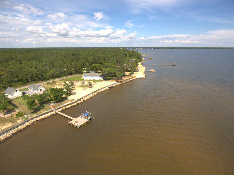 BAYFRONT living'! Enjoy amazing sunsets over Choctawhatchee Bay and a view of both the 331 bridge and the Mid Bay bridge from your yard! This beautiful waterfront lot sits high on the bluff. All the clearing and preparation has already been done. Lot is level and ready for a new home! A few loads of dirt may be needed above the sea wall. Permitted Seawall is already in place. City Water and electric, City Sewer is available. . Robola Bluffs has recorded Restrictive Covenants but there is no HOA in effect at the present time - No HOA fees . New waterfront and interior homes along Red Barn Road are taking place and this is turning out to be a sought after location.. Take a close look and don't miss this opportunity to own one off the few high and dry lots remaining on the bay!