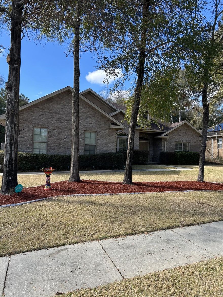 Welcome home to this beautiful 4 bedroom, 2 bathroom home in the desirable Camellia Cove Subdivision. This open and split floor plan offers easy living with no carpeting throughout. Enjoy your own resort-style backyard featuring an enclosed saltwater pool with a poolside bar, epoxy-painted decking with non-slip coating, and color-changing pool lights for day or evening enjoyment. The pool enclosure allows for low maintenance and year-round use. Updates include a 3-year-old roof, new appliances, and a self-cleaning oven with air fryer and convection. The spacious primary suite offers an oversized bath with garden tub and separate shower. Additional features include a fenced, partially wooded yard, new sprinkler system, gutters with leaf guards, and a 10x12 storage shed.