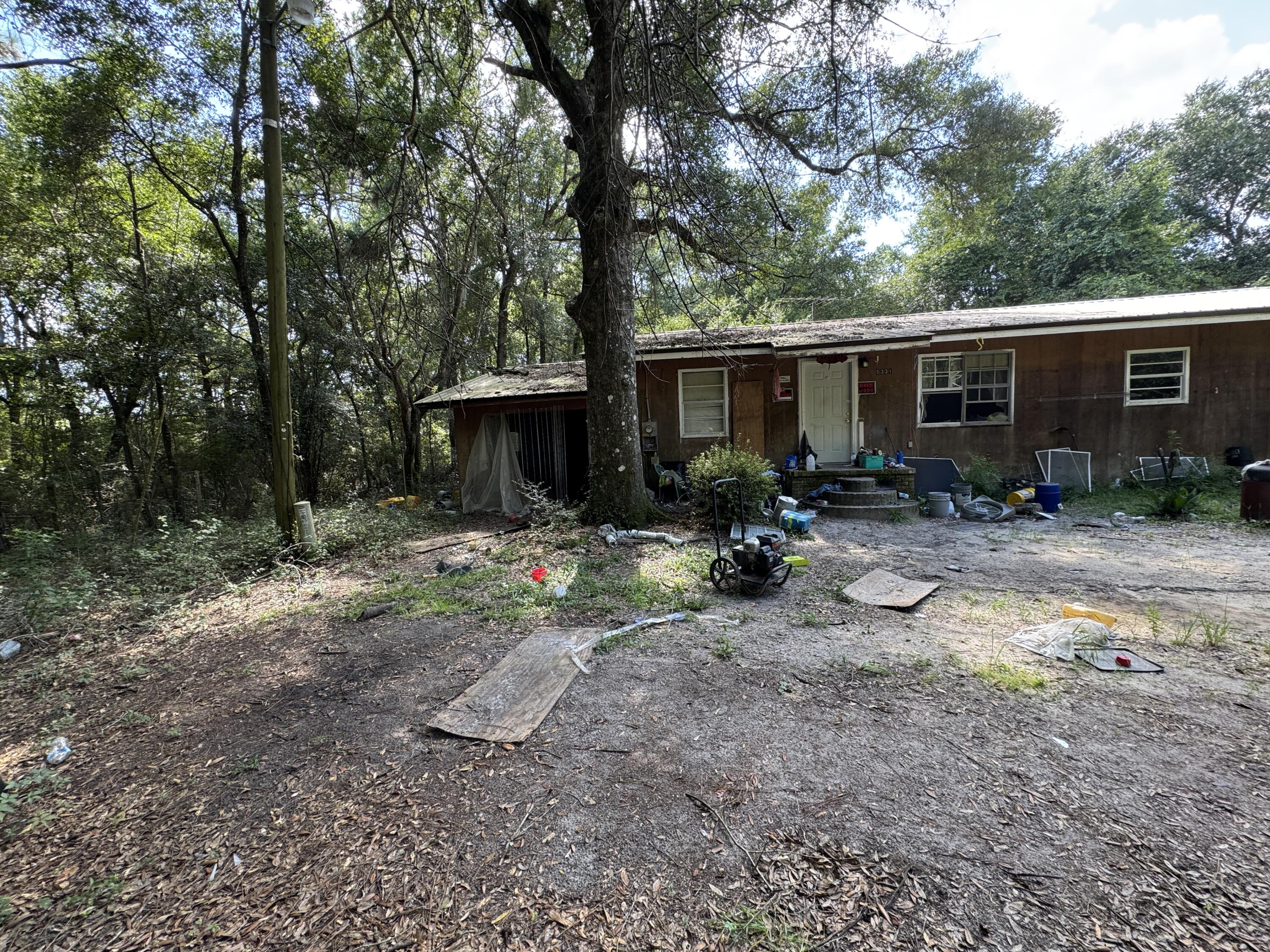 Less than 1/2 mile north of Yellow River. Undeveloped parcels to the south of property. Over 1445 sq ft, the garage is dirt floor and appears to be used as a chicken coop. No HOA. No range, water heater needs replacement, floor seems solid. Buyer to inspect prior to contract.No seller financing. Sold As is! No survey available.Roof does not appear to leak, but house will need cleanup and possible wiring replacement. Home has had central a/c added, but currently no breakers in power panel. East Milton water, and Florida Power is utility. Unknown septic condition. 0.34 acres total including small parcel to east that appears to have a shed on it.