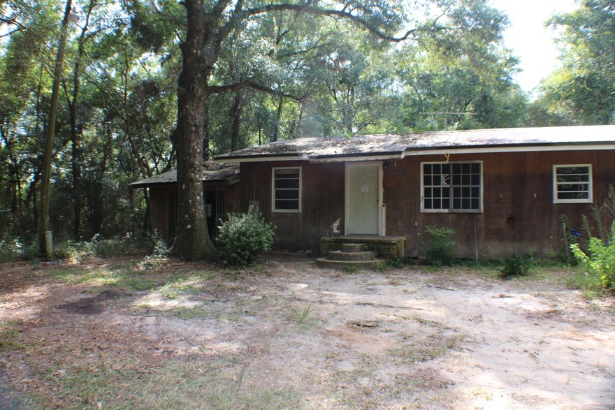 Less than 1/2 mile north of Yellow River.  Undeveloped parcels to the south of property.  Over 1445 sq ft, the garage is dirt floor and appears to be used as a chicken coop.  No HOA.  No range, water heater needs replacement, floor seems solid.  Buyer to inspect prior to contract.No seller financing.  Sold As is!  No survey available.Roof does not appear to leak, but house will need cleanup and possible wiring replacement.  Home has had central a/c added, but currently no breakers in power panel.  East Milton water, and Florida Power is utility.  Unknown septic condition. 0.34 acres total including small parcel to east that appears to have a shed on it.