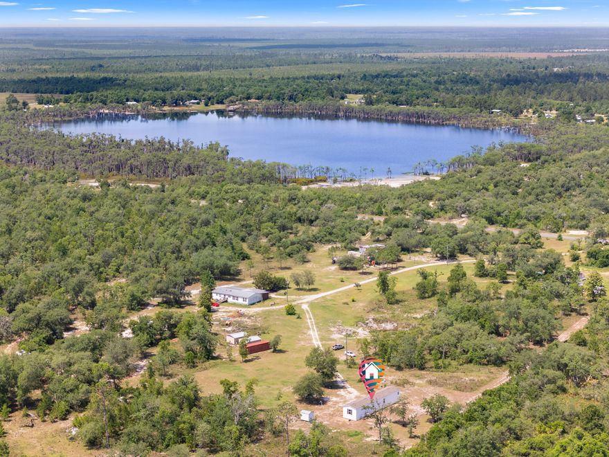 5 ACRES WITH A 2020 MOBILE HOME! Personal residence, second home getaway, hunting camp you decide! Deer run free on this 5-acreage parcel that houses many types of fruit trees: There are a variety of fruit trees including many apple varieties (Honey crisp, Red delicious, Granny smith, and Arkansas black. Mobile Home is modern and spacious with split floor plan. Water system is a newer deep well with newer Septic system and newer power pole so affordable utilities. There is an outside patio area for those family gatherings. 2 storage units come with the property. Marianna and Panama City just a short distance away. Personal driveway as well as shared drive for ingress/egress. Property located in Altha, Fl Calhoun County. Come make this beautiful home your own!  Buyer and Buyers agent to verify all dimensions.