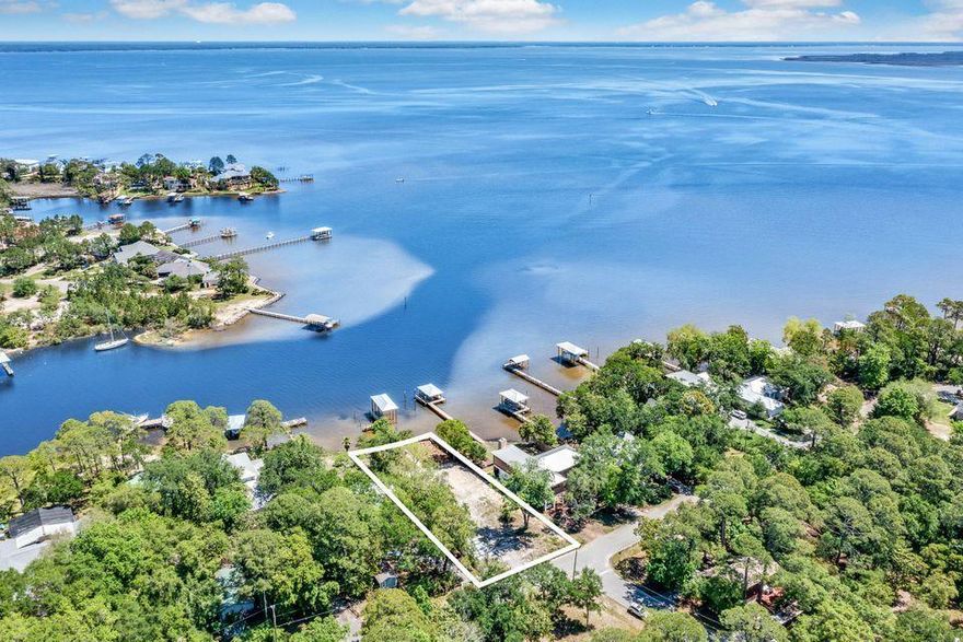 Build your dream home on the water and watch spectacular sunsets from your own backyard! This amazing property is set on deep water Buck Bayou with direct access to the Choctawhatchee Bay. Notable features of the lot include unobstructed bay views, the protection of a newly installed seawall, fully cleared with landscaping near water and new dock with both a covered and uncovered slip. This lot is not governed by any Homeowner's Association so there are no dues and it is not subject to neighborhood specific Rules and Regulations or Architectural Guidelines. Excellent centralized location short distance to Sacred Heart Hospital, Grand Blvd, just East of the Sandestin Resort and near the beaches of South Walton.