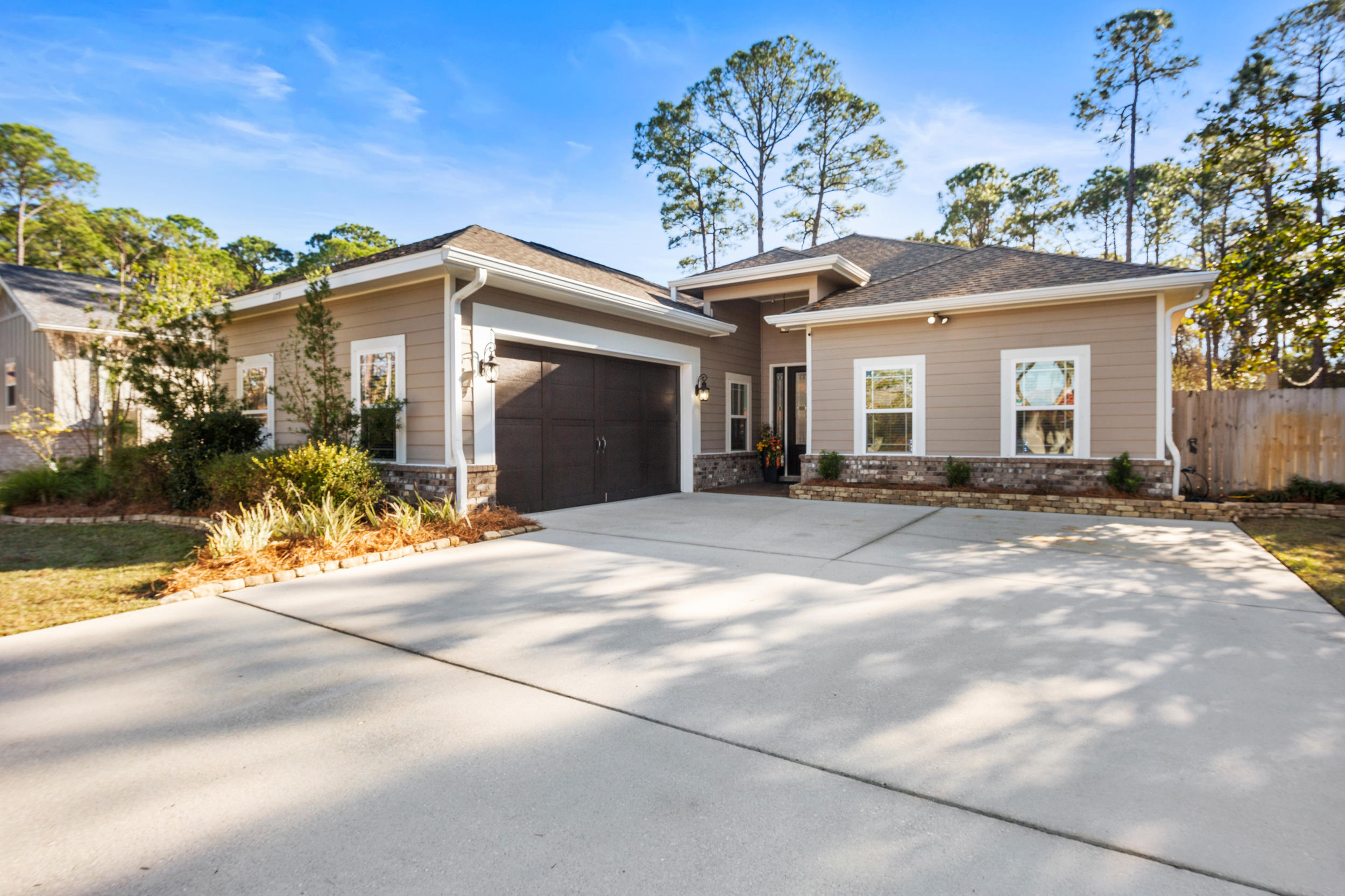 Absolutely stunning contemporary craftsman home in the highly desirable Holiday Shores Estates community of Miramar Beach. Situated on a large manicured lot across from the bay in a quiet, serene setting, this home makes for perfect full time or second home living. Primely located just steps from the community bay access, and only 1.5 miles to the Pompano Joe public beach access, this is a rare opportunity to combine both lifestyles! All while being just 5 minutes to all of the premium dining and shopping of Miramar Beach. Built in 2015, This 1-story residence boasts a huge open design with a split floor plan, and soaring vaulted ceilings in the main living and kitchen areas. Comprised of 4 bedrooms and 3 full baths, modern upgrades include 8' doors, brand new LVP flooring