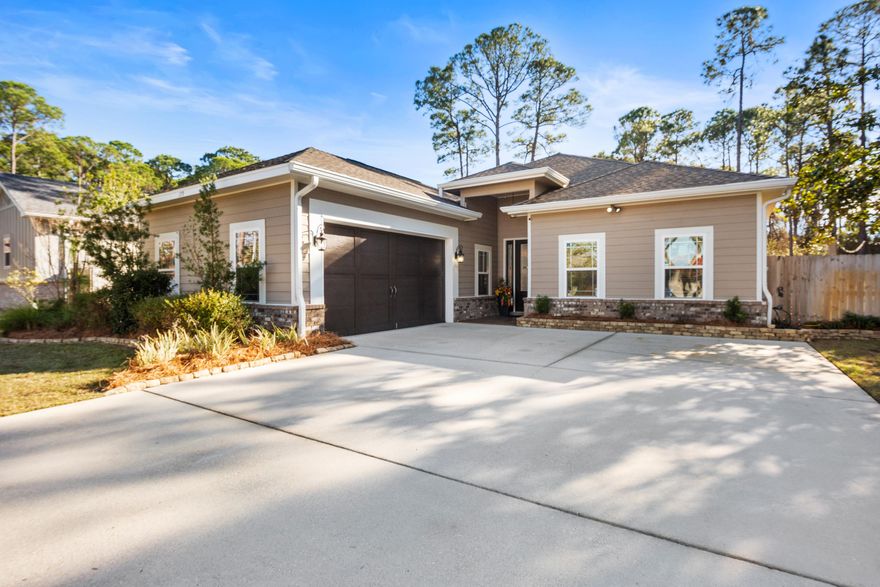 Absolutely stunning contemporary craftsman home in the highly desirable Holiday Shores Estates community of Miramar Beach.  Situated on a large manicured lot across from the bay in a quiet, serene setting, this home makes for perfect full time or second home living.  Primely located just steps from the community bay access, and only 1.5 miles to the Pompano Joe public beach access, this is a rare opportunity to combine both lifestyles!  All while being just 5 minutes to all of the premium dining and shopping of Miramar Beach.   Built in 2015, This 1-story residence boasts a huge open design with a split floor plan, and soaring vaulted ceilings in the main living and kitchen areas.  Comprised of 4 bedrooms and 3 full baths, modern upgrades include 8' doors, brand new LVP flooring