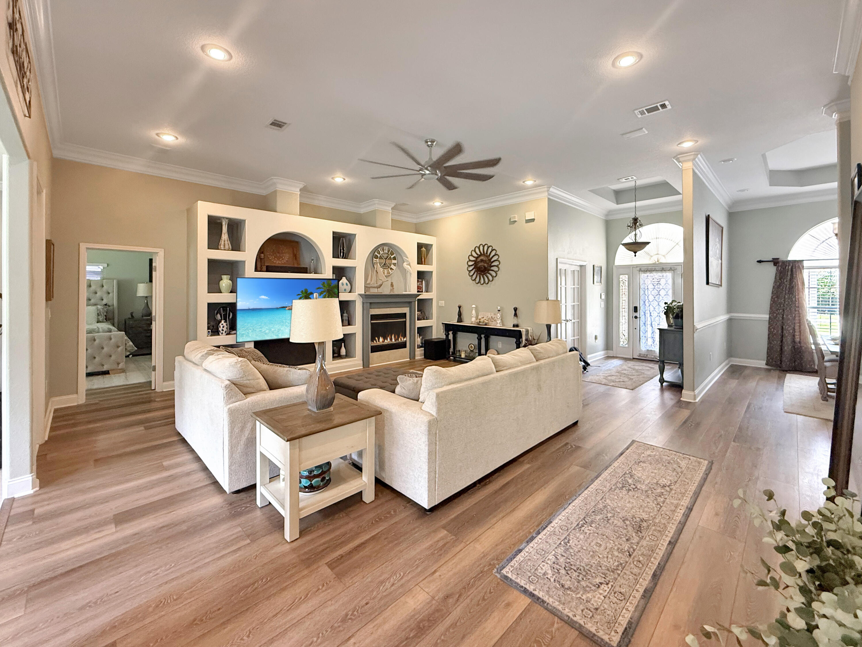 First Showing is July 27, 1-3 PM. Stunning home on a large lot with 11-ft ceilings, crown moulding, and trey ceilings throughout. Features 3 bedrooms plus a flex room, spacious living area with built-ins and gas fireplace, and a large Florida room. Expansive backyard is pool-ready. The master suite offers dual custom closets, separate vanities, walk-in shower, and oversized jetted tub. Kitchen has ample cabinets, and the dining area fits a large hutch and buffet. Guest powder room adds convenience. The 3-car garage is a showstopper with epoxy floors, utility sink, and storage. A perfect blend of comfort and style! Hurry and make this home yours today!! The Kitchen Appliances are only 3 years old, double wall oven. Along with a newer hybrid gas hot water heater.
Main floors replaced with lime stone based LVP for amazing durability only a year old. The gazebo and shed stay.
