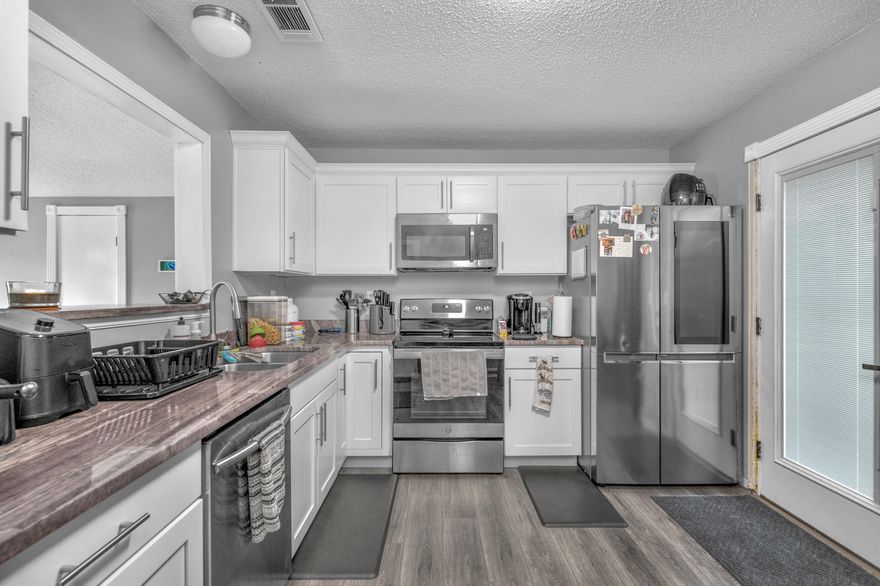 Make your appointment now to see this beautiful 3/2 Home, kitchen with Granite Counter-tops, Stainless Steel appliances, Laminate flooring in main areas, carpet in bedrooms and waterproof Luxury Vinyl in bathrooms.  Fans & lights, blinds, bathrooms, many other extras throughout the home. Roof 2020, AC Outside replaced. Room sizes approx. buyer to confirm.