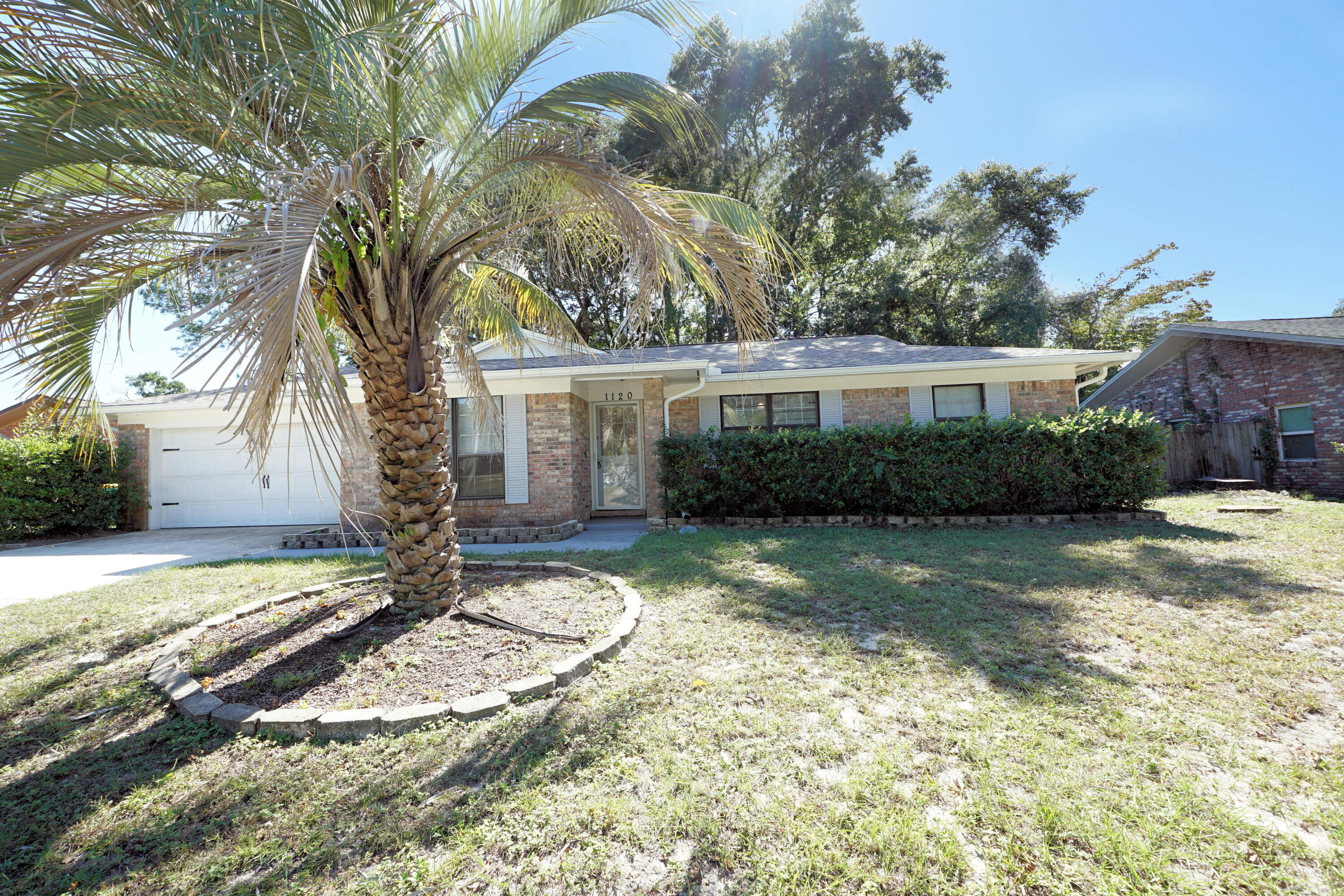 This three-bedroom, two-bath brick home is conveniently located in Niceville, near a variety of stores and restaurants. An open-concept kitchen is the main attraction, with white shaker cabinets, stainless appliances, granite countertops, and a wine fridge. The front room can be used as a living room or home office. The family room is open to the kitchen and has porcelain tile floors. The master bedroom is spacious with a private bath. Two additional bedrooms share an updated hall bath. All bedrooms have laminate wood floors and no carpets. Shade is provided by large mature oak and magnolia trees in the large fenced backyard. A well and sprinkler system provides yard irrigation. The home has been rewired. The roof was replaced in 2024, and HVAC and water heater have been recently updated