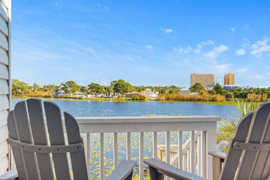 PRICE ADJUSTMENT!  From your back deck you can enjoy your morning coffee while overlooking tranquil Lullwater Lake.  This rental-ready 2 bedroom/2 bathroom condo boasts UPDATED bathrooms, UPDATED Kitchen cabinets and appliances.  Fitted with impact resistance front door and windows, NEW roof, NEW siding, and NEW steps and deck, Lullwater Condominiums has a modern look.   The AC was NEW in 2023 and the Washer/Dryer is NEW in 2024.  Across Front Beach Road to the beach, a half mile from Pier Park, and a mile to Frank Brown Park, this condo has everything you're looking for.  Owner pets are allowed.