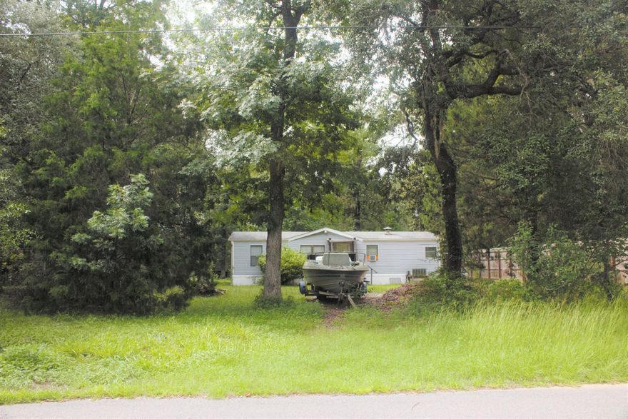 BEAUTIFUL AND AFFORDABLE LOT, JUST 2 BLOCKS AWAY FROM THE CHOCKTAWACHEE BAY, FREEPORT, FL!!! LOTS of possibilities are found in this peaceful home site. Conveniently located, approx. 1 mile to the boat ramp, 4 miles to Niceville, FL, and just 14 miles to Eglin AFB. Short commute to restaurants, hospitals, schools, shopping centers, Destin, FL and our embellishing white sugar sandy beaches. The double wide mobile home represents no value to this sale and seller makes no warranty on its condition.