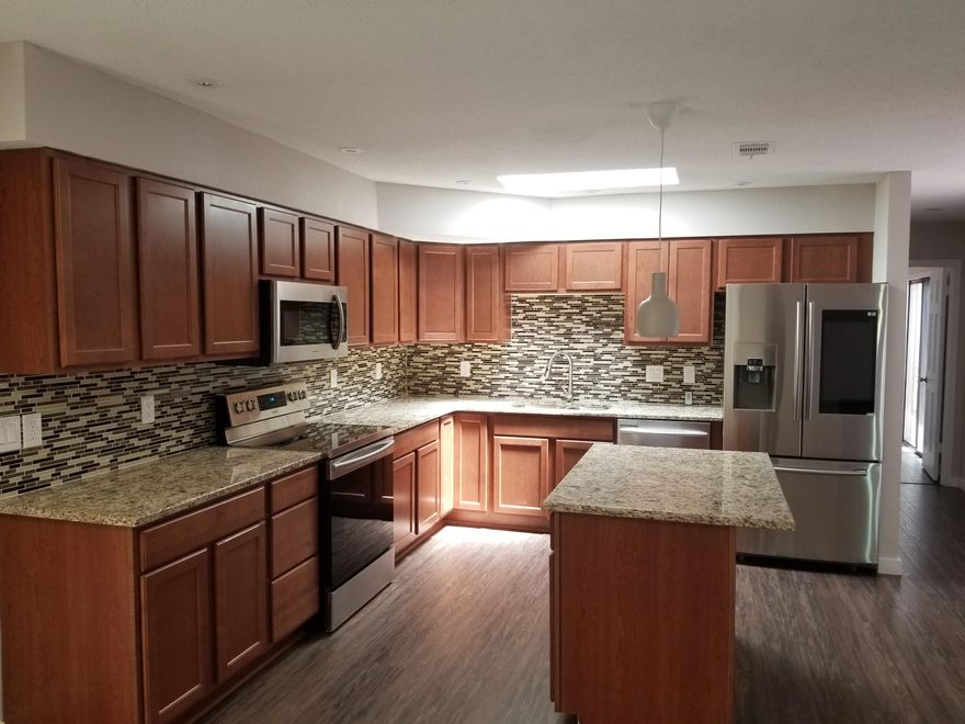 Totally Customized Spacious One story Home.New roof ,Custom kit cabinets , kit island ,granite counter tops ,top of the line fixtures , faucets and stainless steel appliances ( Smart camera Samsung stainless steel fridge ).Top of the line laminate flooring ,new updated bathrooms ,split bedroom plan , outside screened in atrium , spacious with open floor plan.Comfortable front yard with decking and garden like shrubbery for privacy. Pls text only for all info .Easy show ,Buyers to verify all info and data.