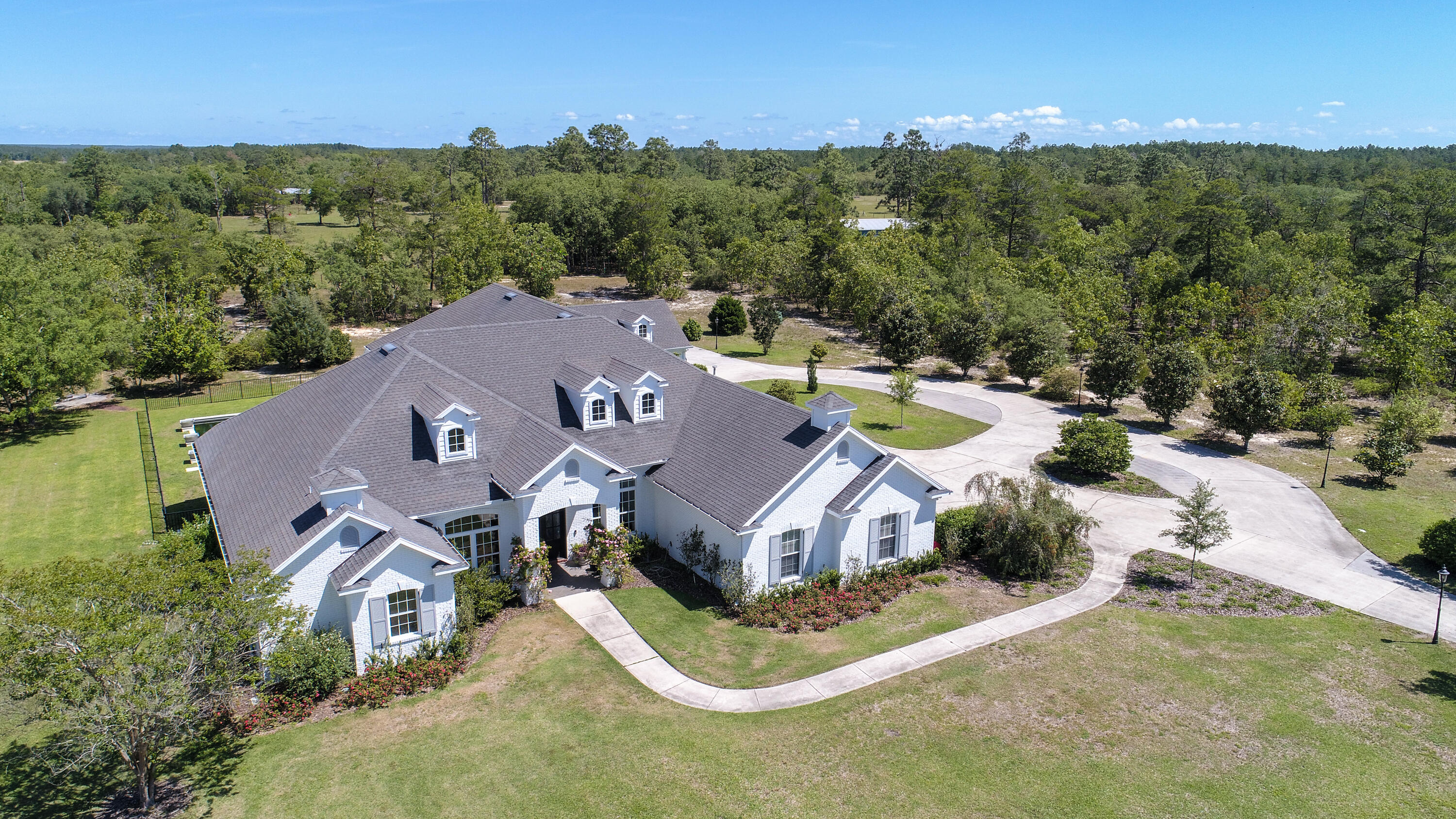 Privacy, amenities and the pinnacle of estate living is embodied at this expansive 4,625 square foot home nestled on 9+ acres in the prestigious community of Windswept Estates. Offering an architecturally significant design and flawless flowing and floor plan for effortless living, this 5 bedroom, 5-and-one-half bath home provides a truly turnkey and fully furnished product ideal for both primary and secondary living opportunities. Fully renovated by Geoff Chick & Associates, British design elements inspire the exterior of the home, while contemporary coastal influence fills the interior with high-end finishes, top of the line appliances, and purposeful natural light.