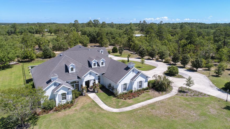 Privacy, amenities and the pinnacle of estate living is embodied at this expansive 4,625 square foot home nestled on 9+ acres in the prestigious community of Windswept Estates. Offering an architecturally significant design and flawless flowing and floor plan for effortless living, this 5 bedroom, 5-and-one-half bath home provides a truly turnkey and fully furnished product ideal for both primary and secondary living opportunities. Fully renovated by Geoff Chick & Associates, British design elements inspire the exterior of the home, while contemporary coastal influence fills the interior with high-end finishes, top of the line appliances, and purposeful natural light.