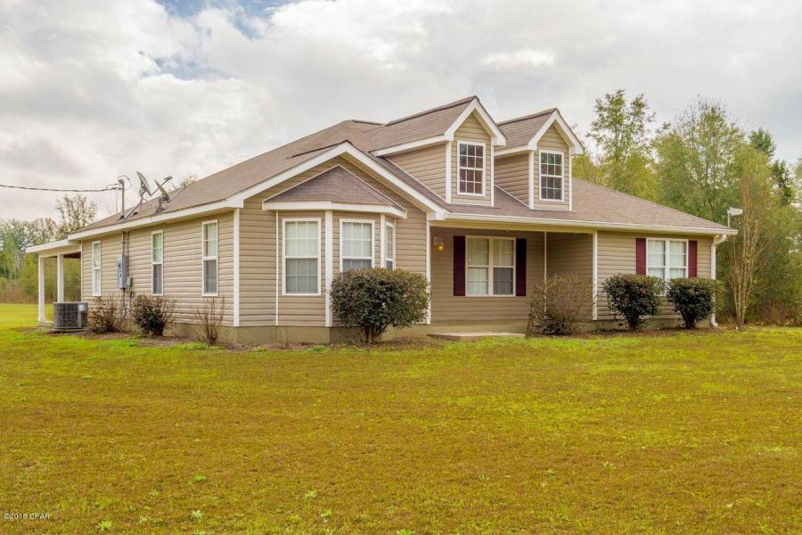 Seller is gifting a Home Warranty, white you enjoy a quiet country lifestyle in this pristine home, offering a split floor plan and over 18 acres of gorgeous land. Approach via the long private drive, which loops around providing easy access to the back of the home and large detached garage. Inside, the beautiful main living area boasts an open floor plan, including a large kitchen with stainless steel appliances, generous counter space and great cabinet storage. Overall, a pleasant and inviting space. A little less formal, find a fantastic den with rustic wood paneling just off the kitchen. Also find a convenient utility room to keep laundry out of sight. Outside, Kick back and relax on the covered porch while looking out over the scenic landscape.