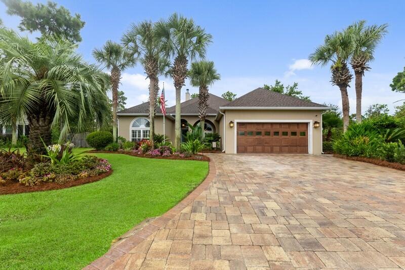 Your private oasis! Come see this well-appointed home in the desired gated community of Pelican Bay. Custom built one-story stucco home with 3-bedrooms and 2-bathrooms located on a quiet cul-de-sac. Meticulous care has been taken in the upkeep of this home. Curb appeal abounds with lush, tropical landscaping (which was recently voted Pelican Bay's Best Garden) accented by professionally designed/installed landscape lighting. An in-ground irrigation system makes maintaining the landscaping effortless. As you pull up, you will notice the newer brick paver drive/walkways and the well-maintained exterior to include a new roof and gutters. One of the walkways leads to a covered front porch and the other leads to one of two, double-wide gates, opening into a big backyard, which backs to