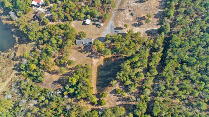 Do not miss this opportunity! Take a look at this beautifully updated manufactured home on 10 acres. You will love the privacy that this property offers. The property is fenced with a gate entrance. You will love the well maintained drive and grounds. The two barns offer enough storage or space for your animals. The pond is beautiful and can be seen from the massive porch. The home features four bedrooms and two bathrooms. The closets are huge. The fireplace and vaulted ceilings make this feel like home. The floor plan is open with split bedrooms. You are going to love the spa like master bed and bath with office space. This is country living at its finest so close to everything you need.